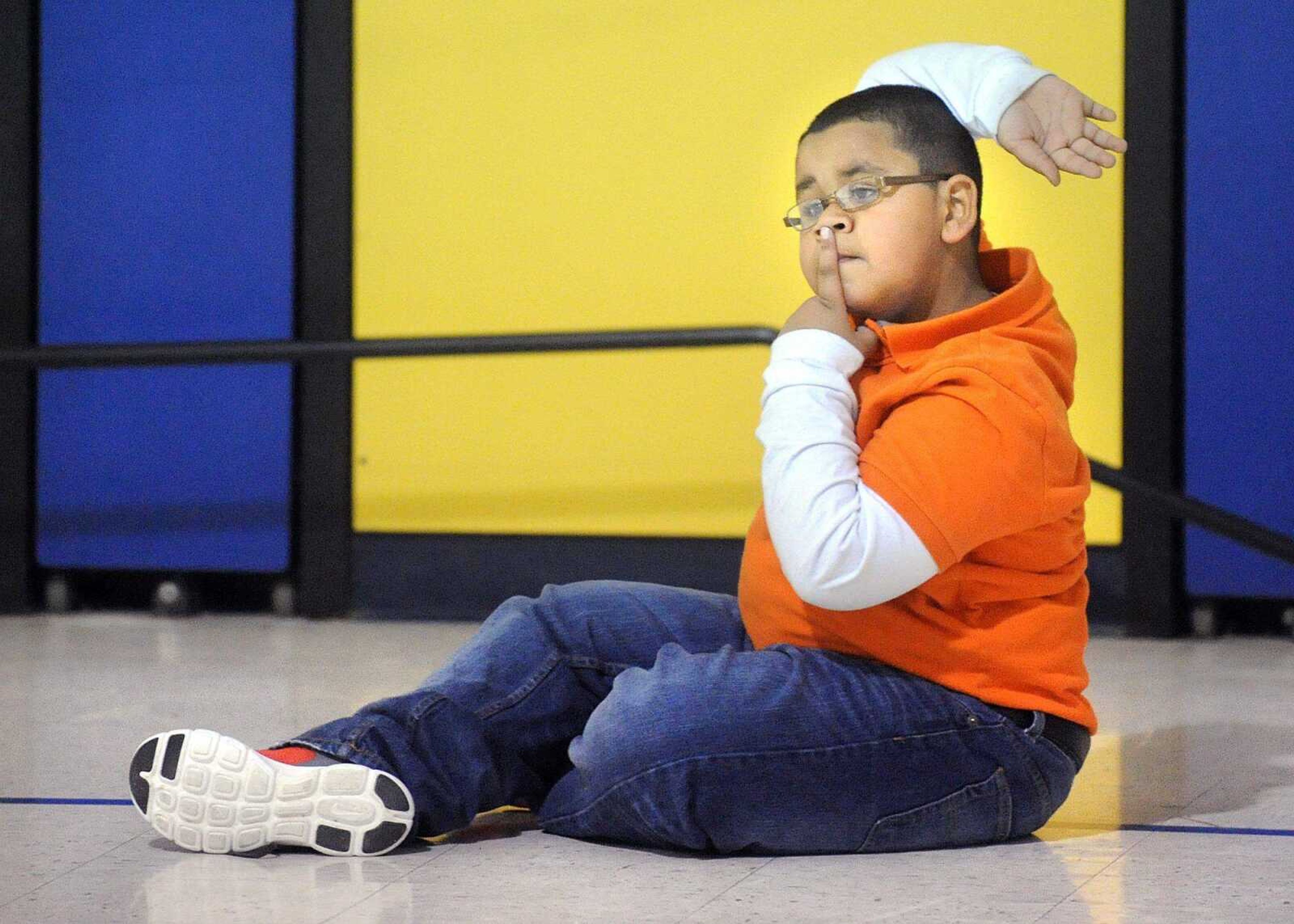 Cameron Senn raises his hand to be picked for a dodge ball team Friday at Scott City Elementary School. (Laura Simon)