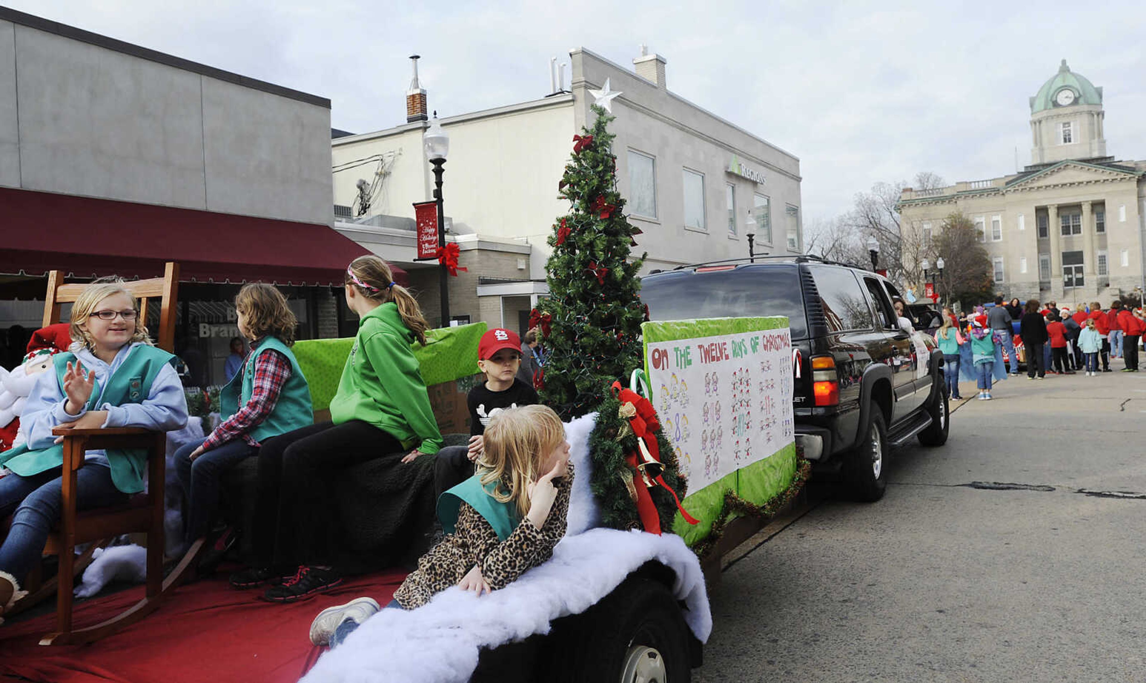 Children wave to the crowd as their float moves down South High Street during the Jackson Jaycee Foundation Christmas Parade Saturday, Dec. 1, in Jackson.