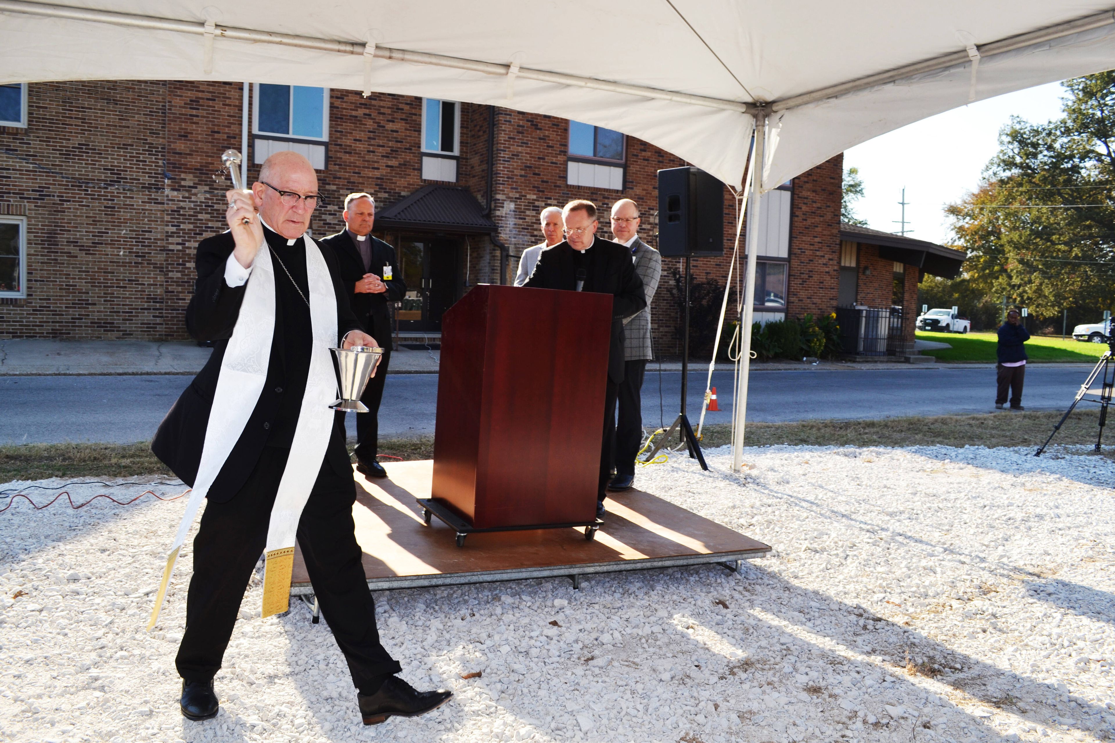 The Most Rev. Bishop Edward M. Rice blesses the space for the new facility by sprinkling the ground with holy water Tuesday, Oct. 29, during the groundbreaking ceremony of Saint Francis Healthcare System’s new rural health clinic in East Prairie.