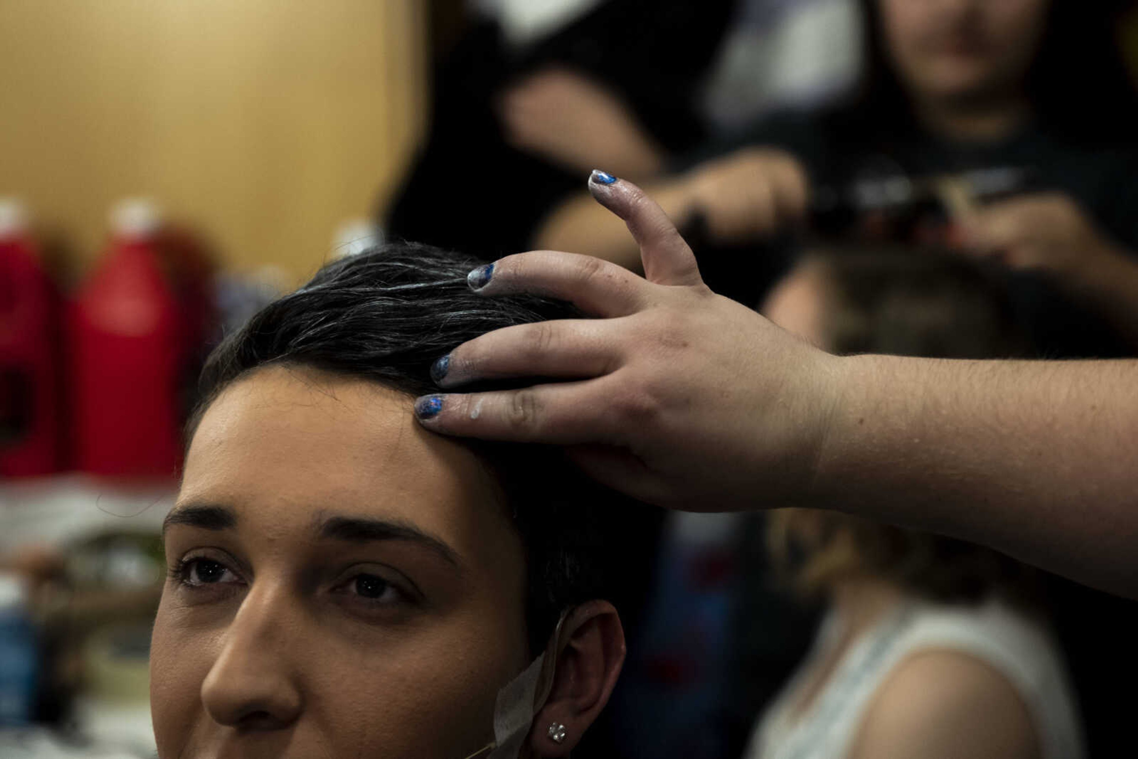 Russell Allen, 18, sits while Kali Whitworth fixes his hair as he transforms into the character of Bill Austin for Cape Central High School's spring musical production of "Mamma Mia!" Wednesday, April 10, 2019, in Cape Girardeau.