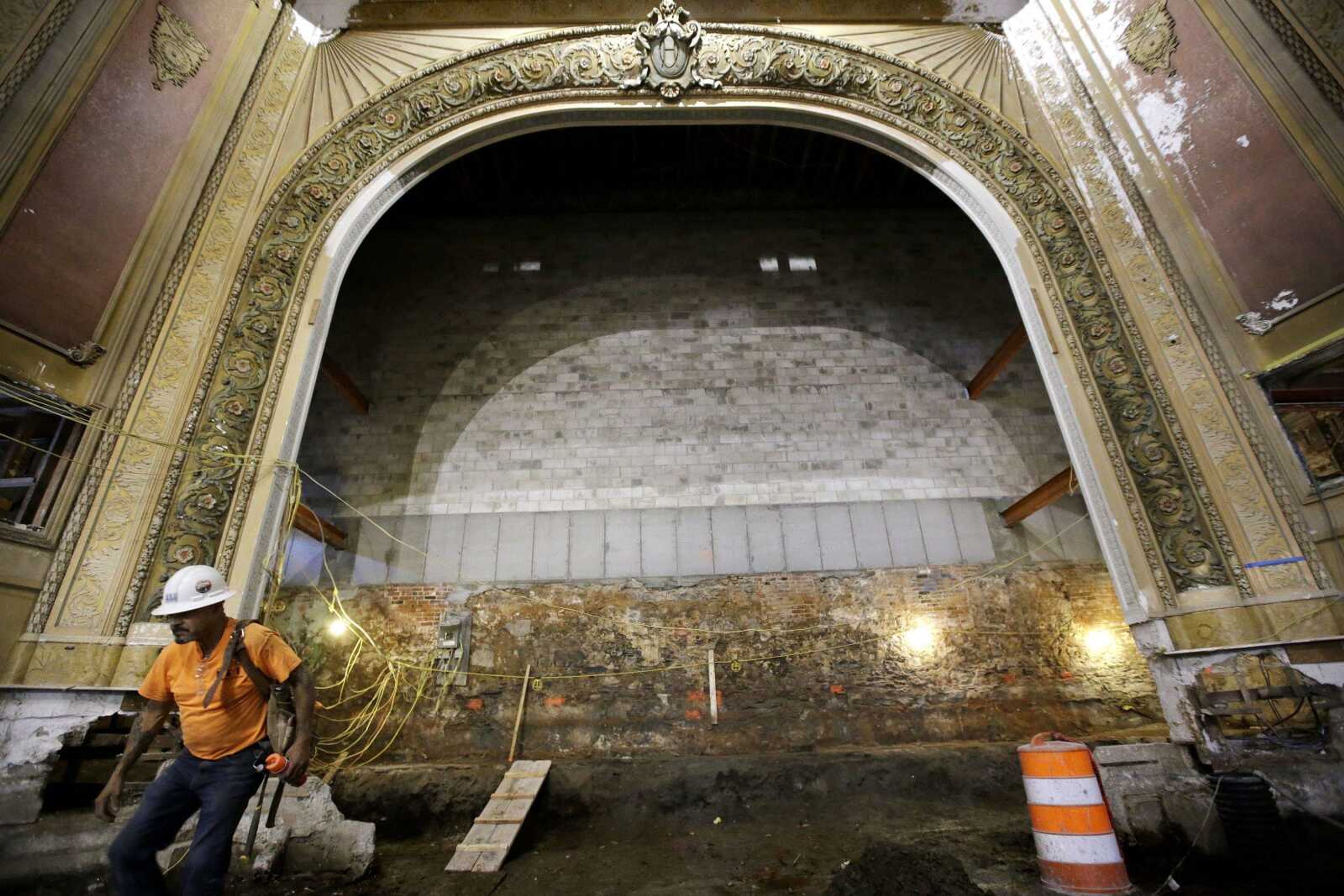 Laborer Fred Marrero of Cranston, Rhode Island, walks away from the proscenium arch May 23 in the Newport Opera House, in Newport, Rhode Island.