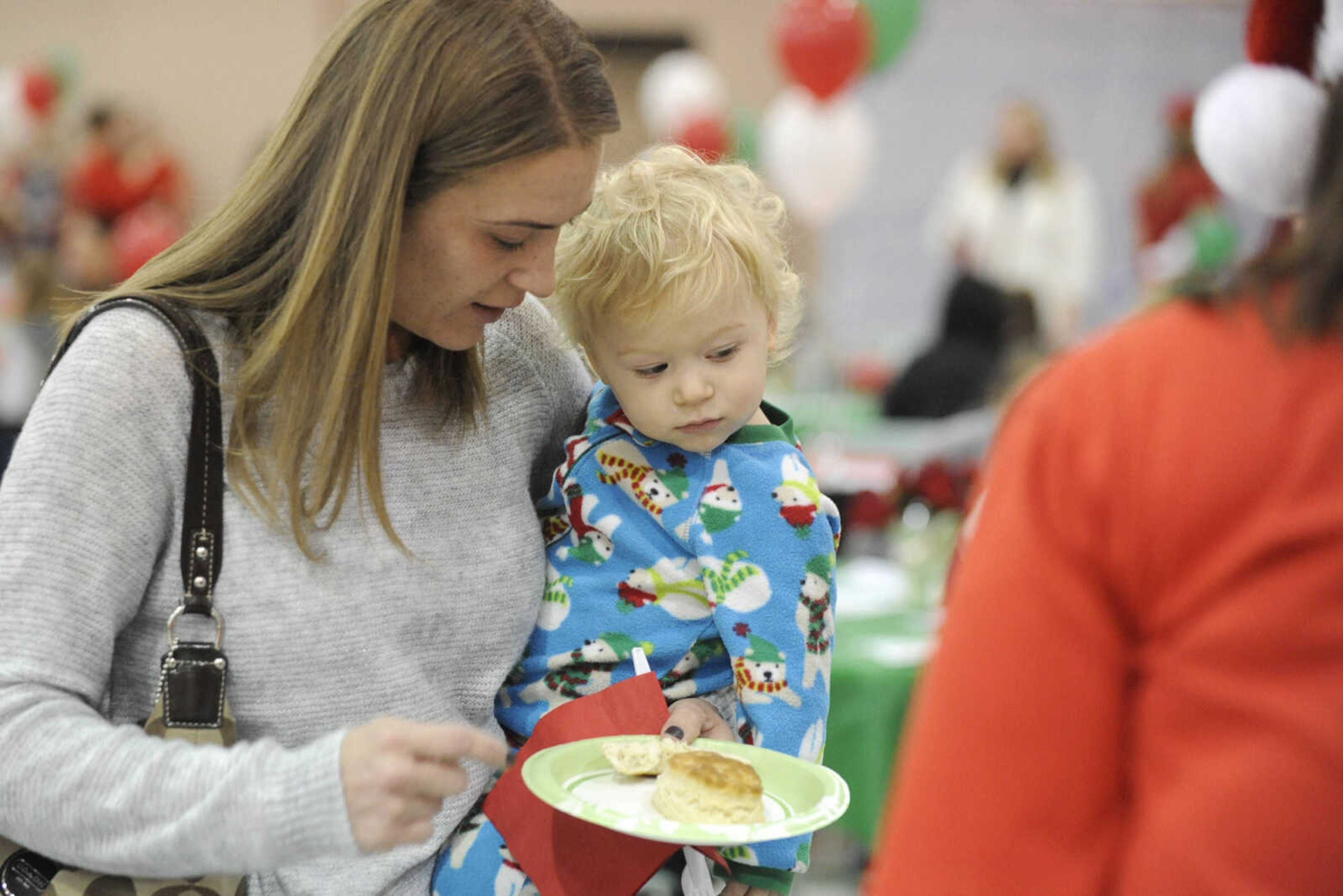 GLENN LANDBERG ~ glandberg@semissourian.com

Evan McLain and his mother Mindy get breakfast before visiting with Santa during a fundraiser for the Cape Girardeau Parks and Recreation Foundation Saturday, Dec. 13, 2014 at the Osage Centre.