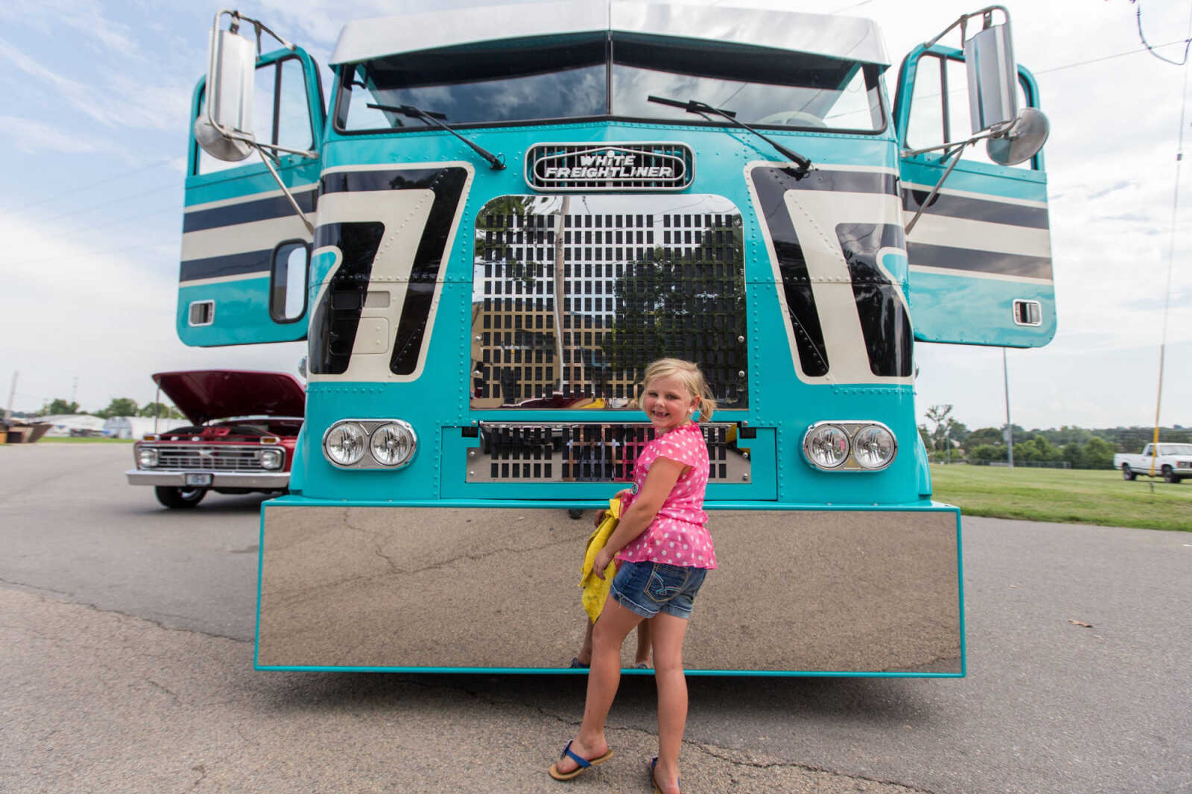 GLENN LANDBERG ~ glandberg@semissourian.com

Hollie Aslinger wipes down the front of her fathers 1995 Freightliner FLB during the Rev'n Rods & Heartland Music Tour stop at Arena Park Tuesday, July 19, 2016 in Cape Girardeau.