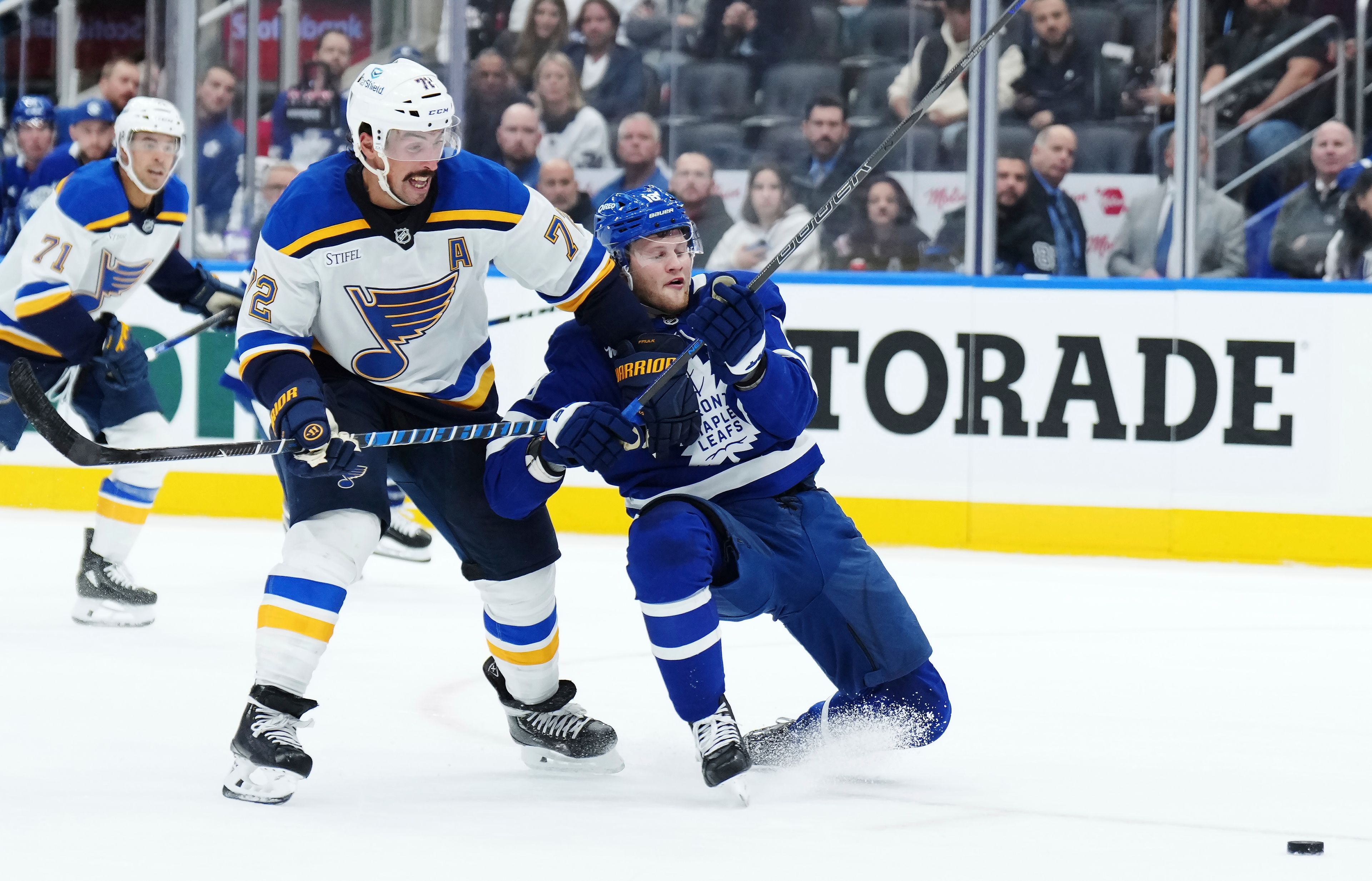 St. Louis Blues defenseman Justin Faulk (72) checks Toronto Maple Leafs forward Steven Lorentz (18) during second-period NHL hockey game action in Toronto, Thursday, Oct. 24, 2024. (Nathan Denette/The Canadian Press via AP)