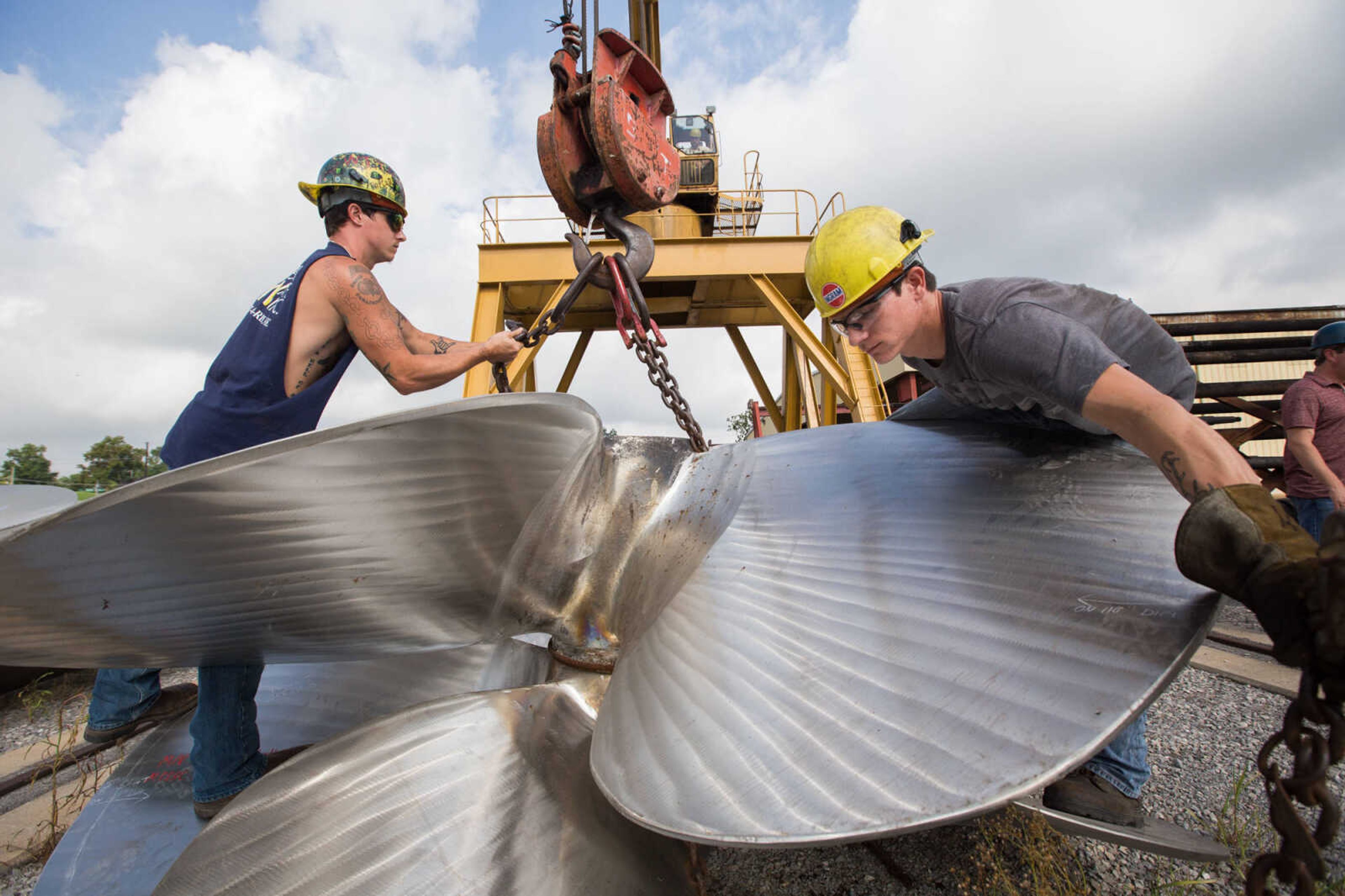 GLENN LANDBERG ~ glandberg@semissourian.com

Cousins, Keegan and Kyler Hale hook up chains to a propeller being moved outside the repair shop at Missouri Dry Dock and Repair Co. in Cape Girardeau Wednesday, July 28, 2016.