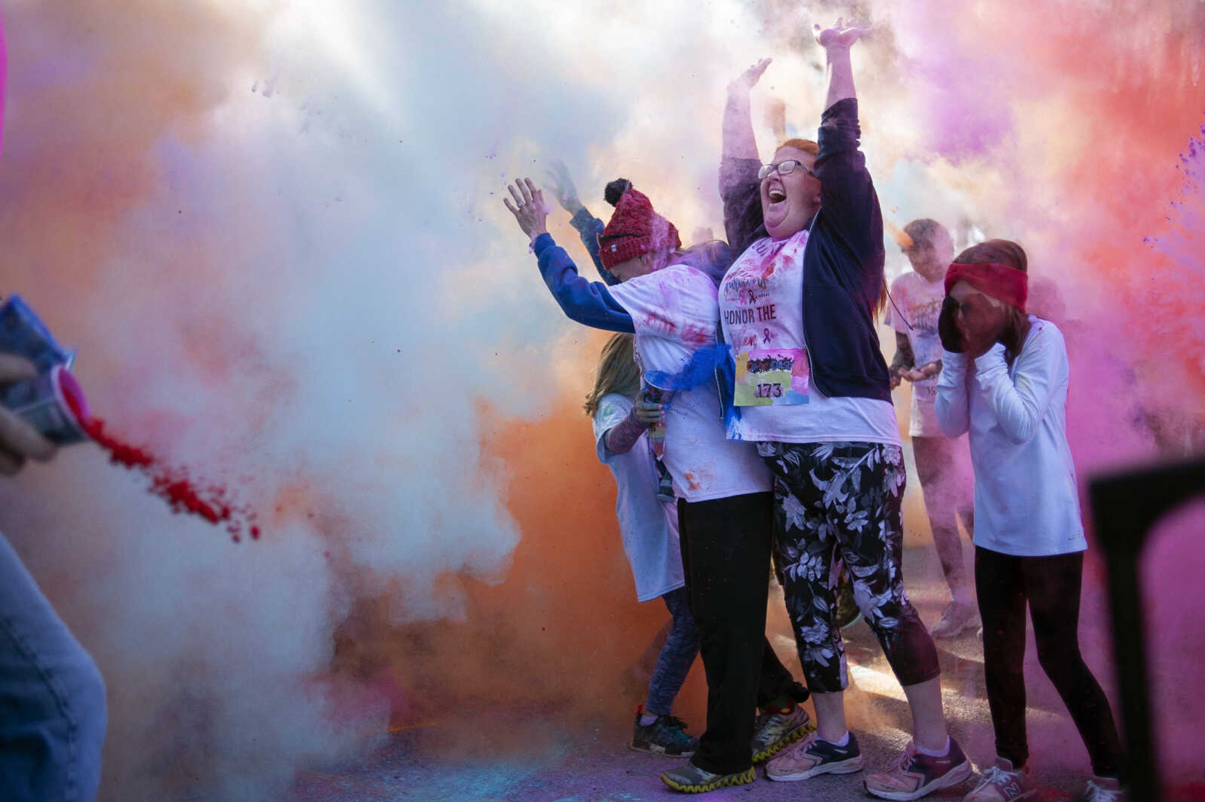 Lindsay Adams of Cape Girardeau gets covered in coloring during a group color toss at the Saint Francis Foundation's first Color Dash on Saturday, Oct. 12, 2019, at Arena Park in Cape Girardeau.&nbsp;