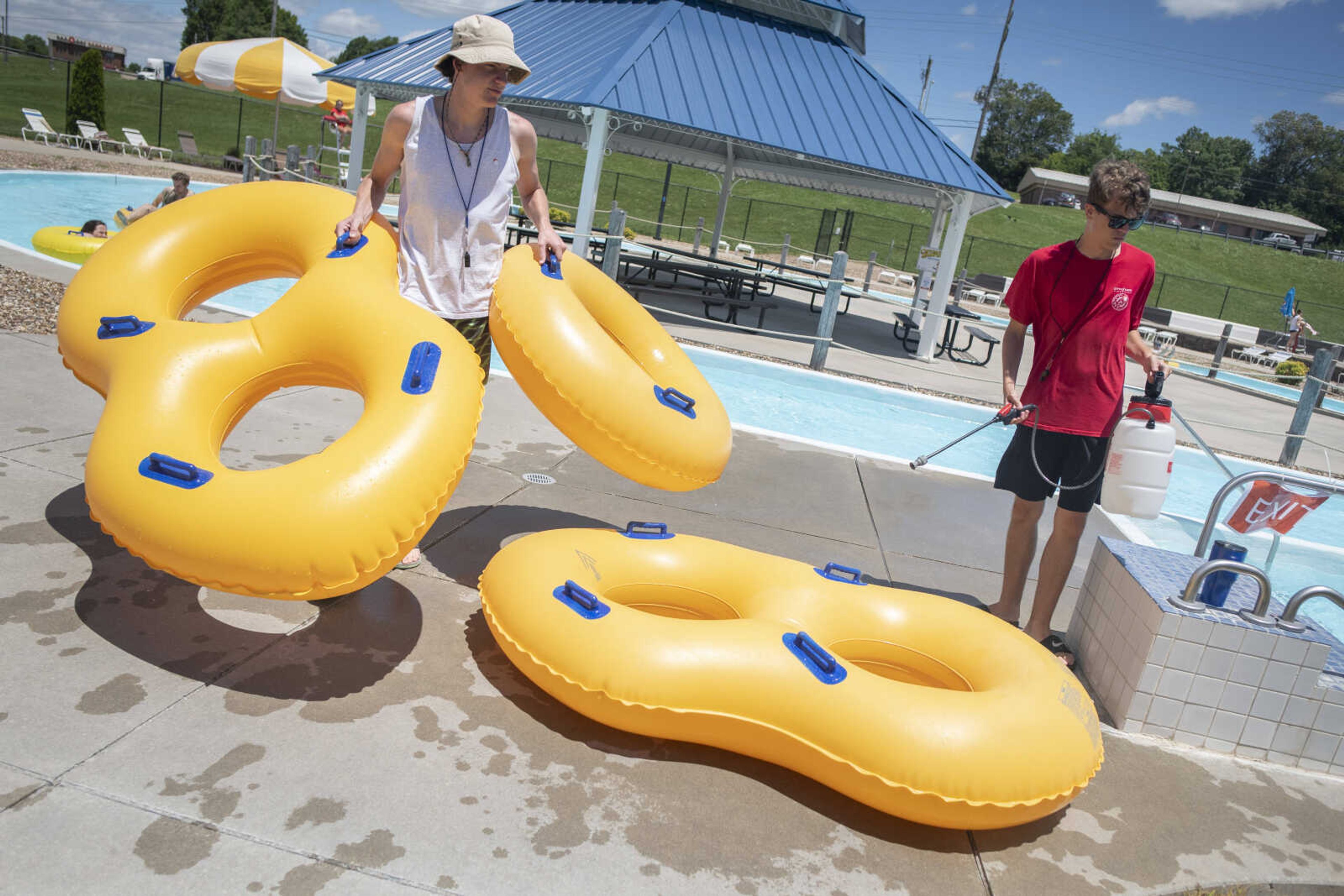 Cape Splash Family Aquatic Center employee Drew Noel (left), 17, of Cape Girardeau removes tubes used in the lazy river while Noah Schuchardt, also 17 and of Cape Girardeau, tends to tube sanitizing Wednesday, June 10, 2020, at the waterpark in Cape Girardeau. Sarah Wichern, City of Cape Girardeau Aquatic Coordinator, said the facility reopened Monday. She said the center is open seven days a week with sessions from 11 a.m. to 2 p.m. and 3 to 6 p.m. The hour between the two sessions is used for sanitizing of the facility, she said. Wichern said each session is being limited to 500 people plus pass holders.