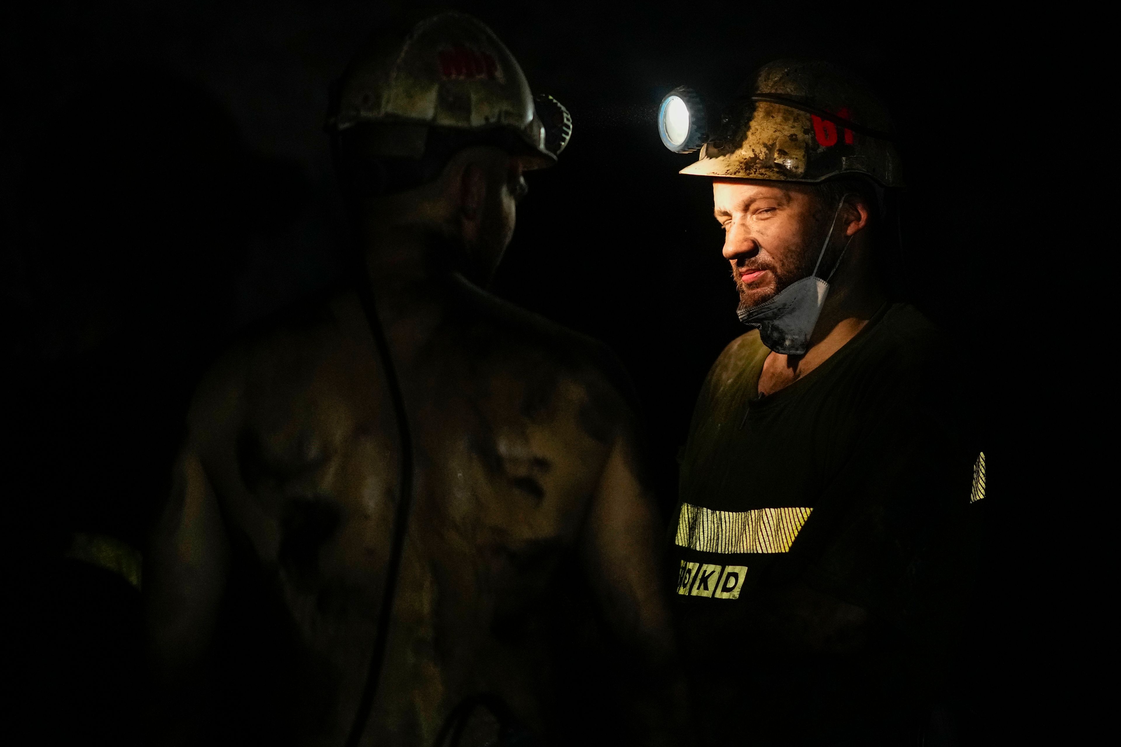 Miners talk in a shaft of the CSM coal mine in Stonava, Czech Republic, Monday, Oct. 14, 2024. (AP Photo/Petr David Josek)