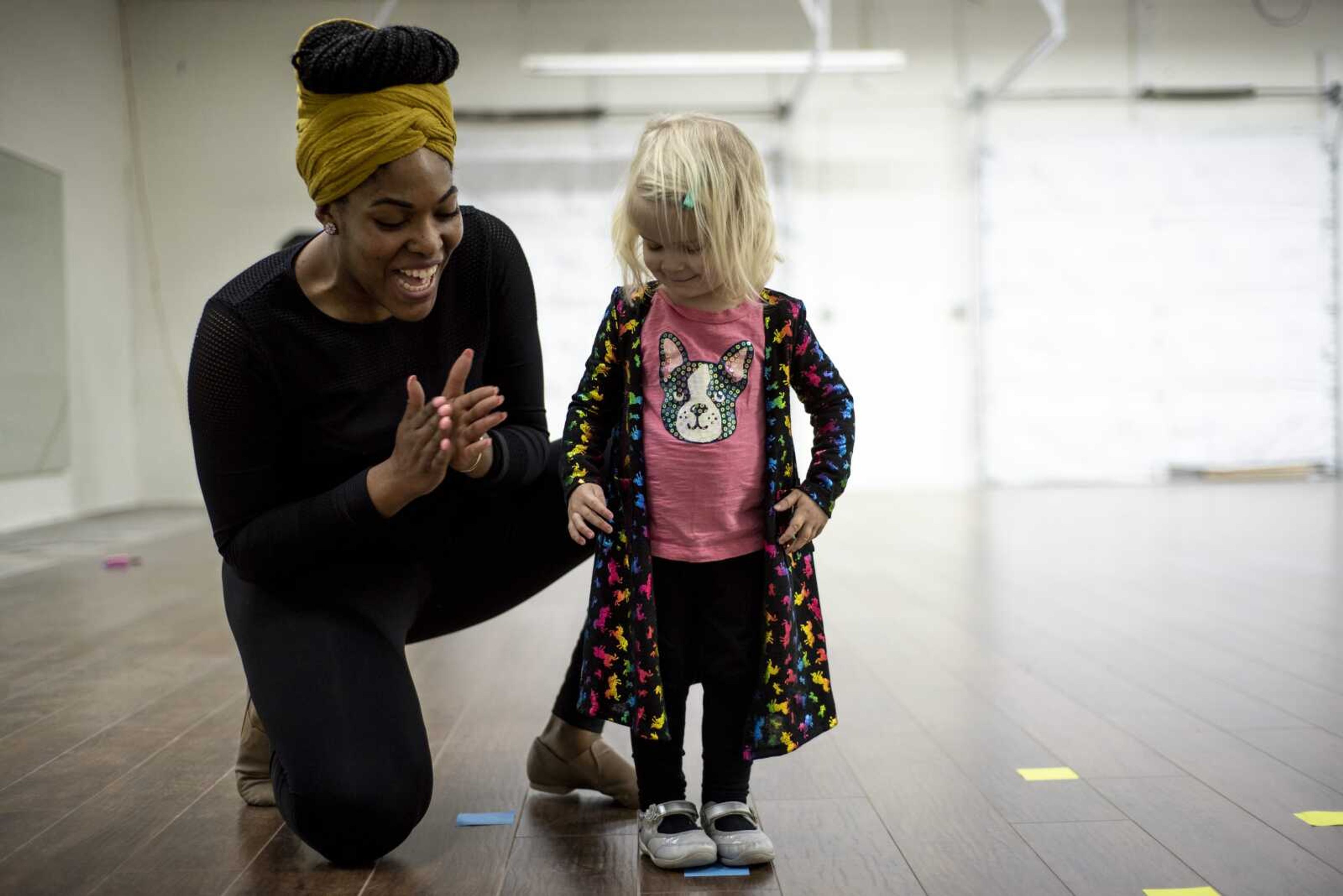 Jecala Amos claps for Greta Oslund, 2, after she completed an exercise during the "baby hop" class Monday at Dance City Monday morning in Cape Girardeau.