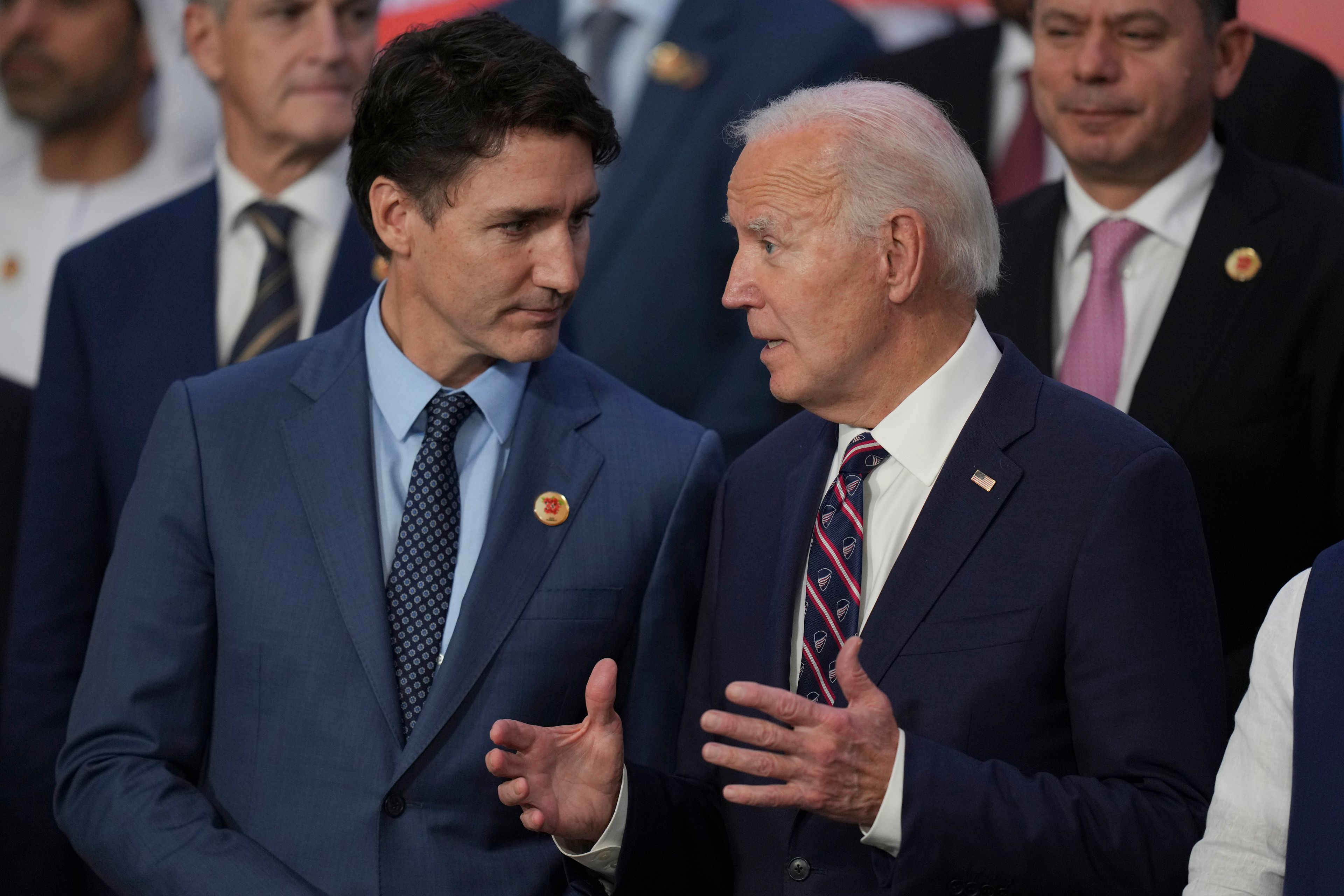 U.S. President Joe Biden, right, talks with Canada's Prime Minister Justin Trudeau as world leaders gather for a G20 Summit group photo, in Rio de Janeiro, Tuesday, Nov. 19, 2024. (AP Photo/Silvia Izquierdo)