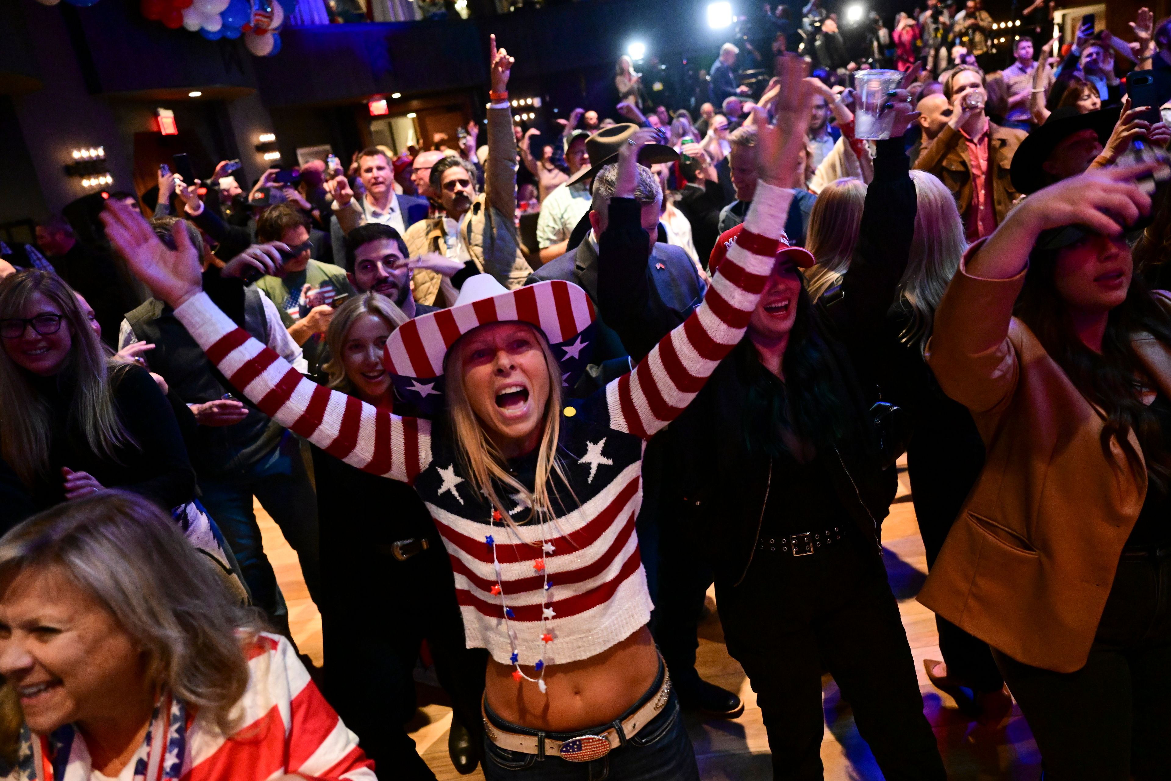 Supporters cheer at an election night watch party for Republican Montana Senate candidate Tim Sheehy, Wednesday, Nov. 6, 2024, in Bozeman, Mont. (AP Photo/Tommy Martino)