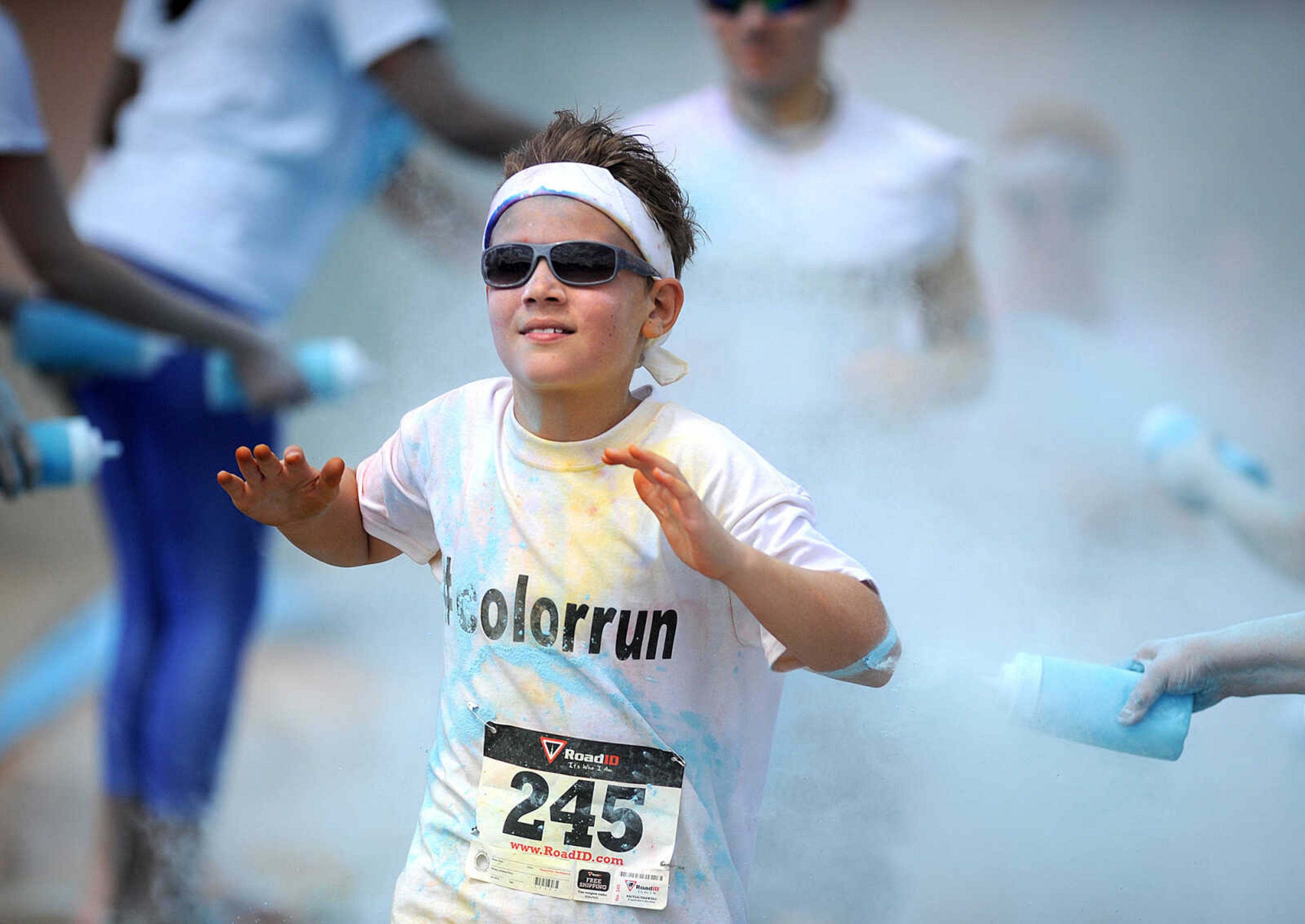 LAURA SIMON ~ lsimon@semissourian.com

Participants in the Color Me Cape 5K are sprayed with blue powder at the final color station on Main Street, Saturday, April 12, 2014, in Cape Girardeau.