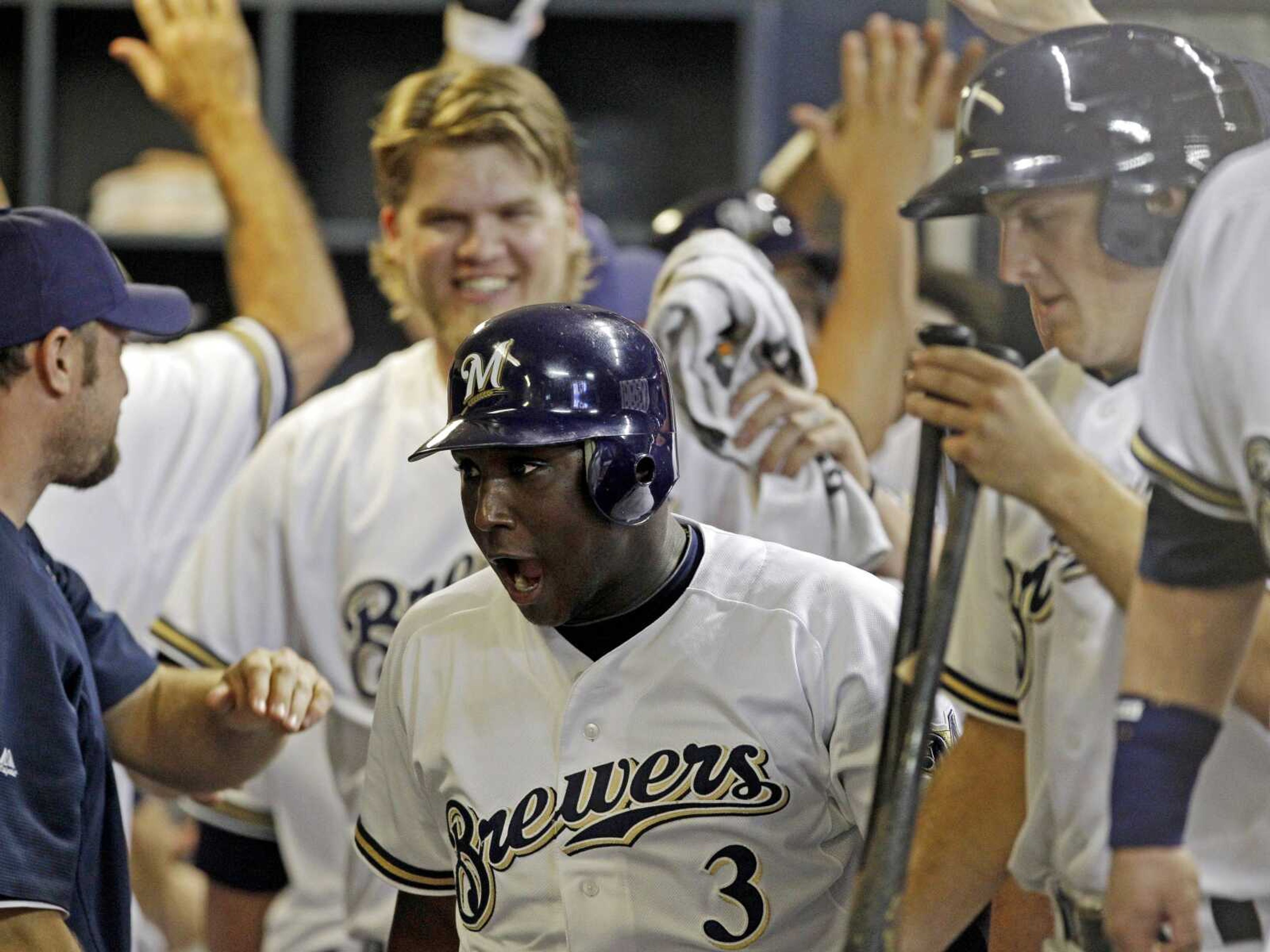 Milwaukee Brewers' Yuniesky Betancourt (3) celebrates in the dugout with teammates after hitting a three-run home run during the fifth inning of a baseball game against the St. Louis Cardinals Tuesday, Aug. 2, 2011, in Milwaukee. Teammates Ryan Braun and Prince Fielder also scored on the play. (AP Photo/Morry Gash)