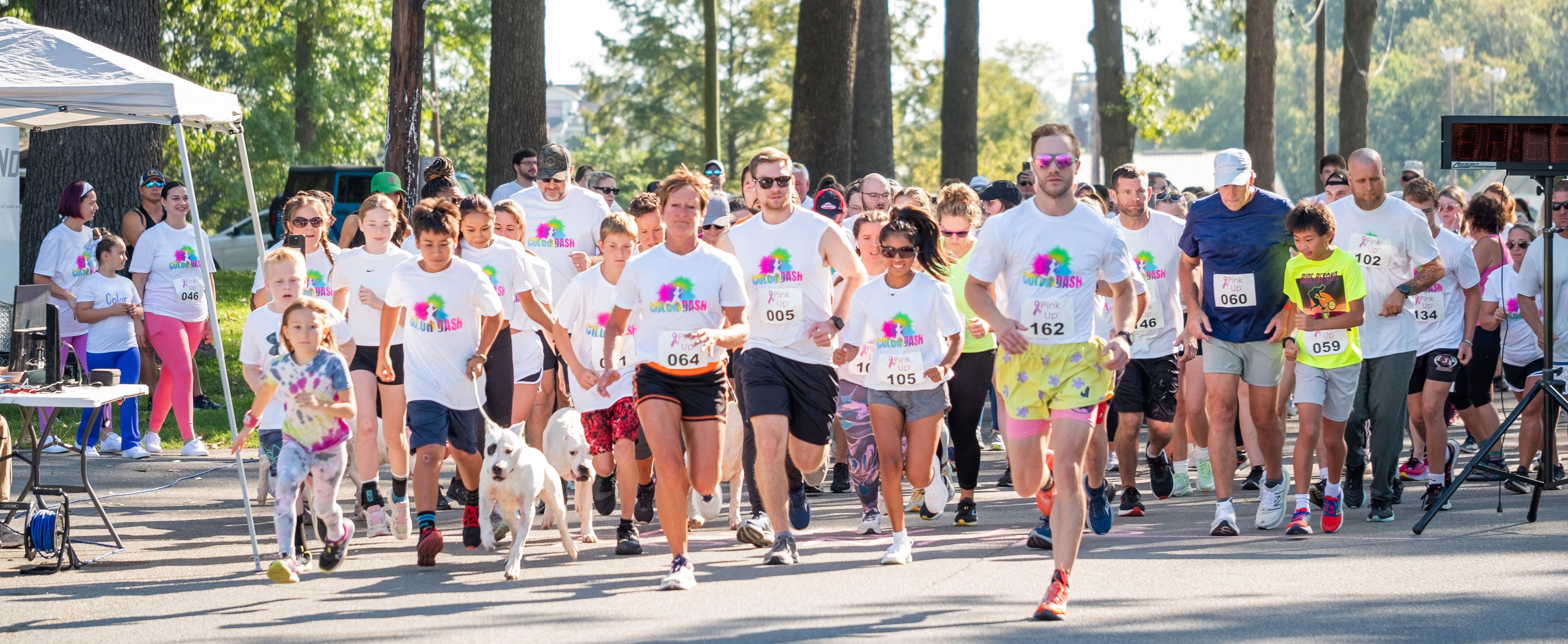 Participants of all ages gather at the starting line, setting off together for the 5K and 1-mile fun walk.
