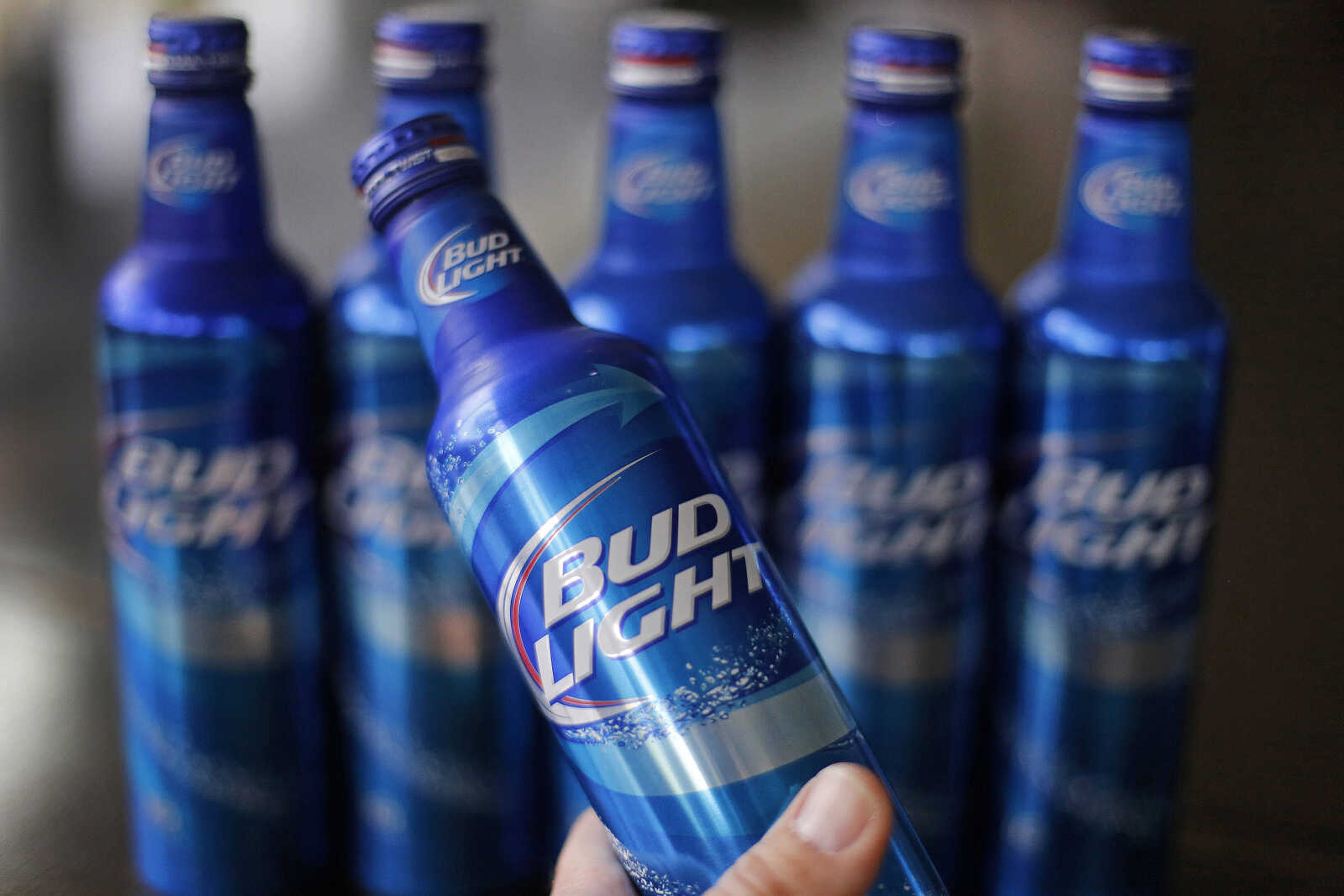 Aluminum bottles of Bud Light beer are on display at Alcoa headquarters in Pittsburgh. Anheuser-Busch is apologizing Tuesday for a slogan that appeared on bottles, saying Bud Light removes the word "no" from drinkers' vocabularies. (Associated Press)