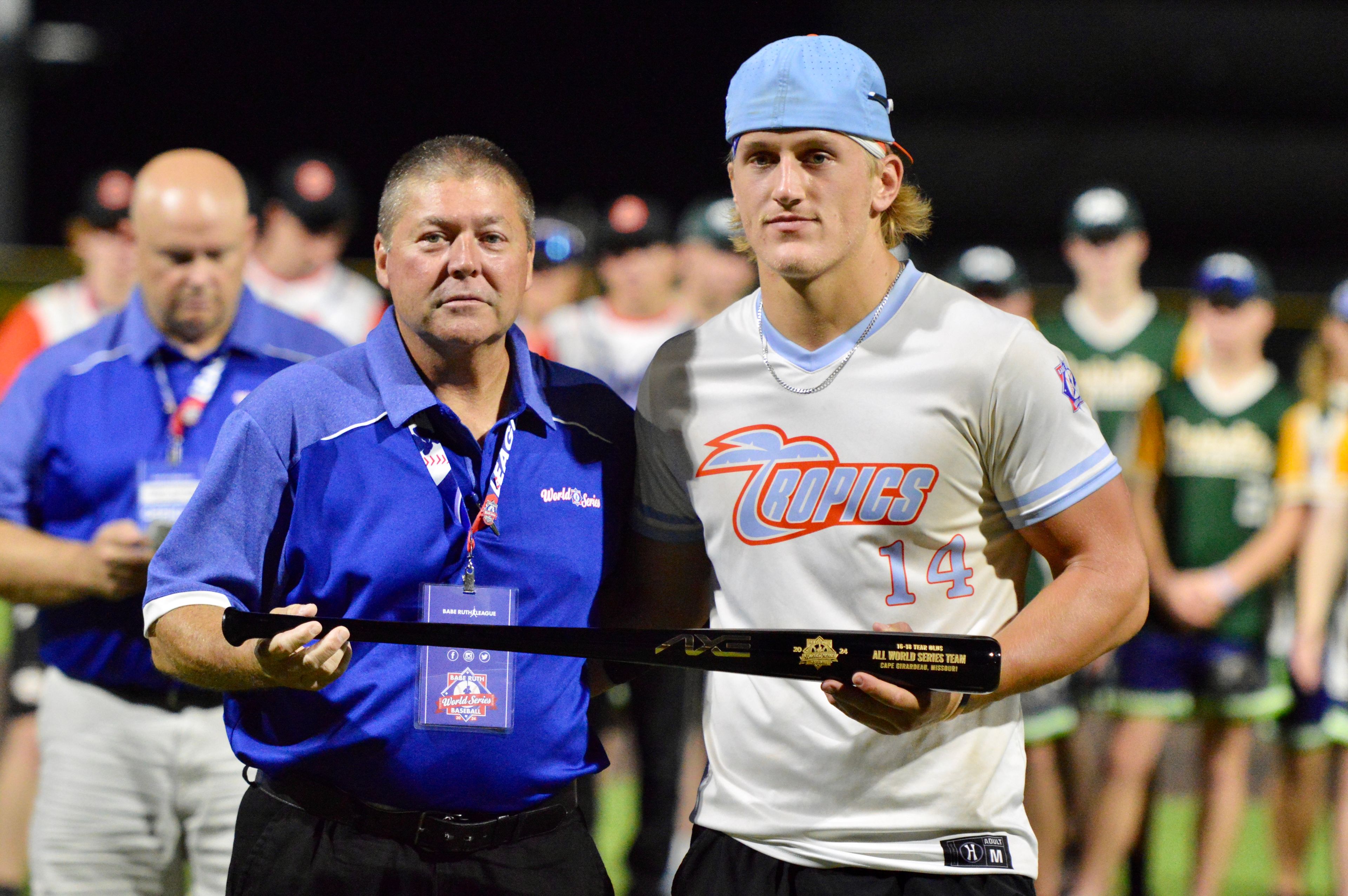 Southeast Tropics’ Trey Benthal is handed an All-World Series team trophy at the Babe Ruth World Series on Thursday, Aug. 15, at Capaha Field in Cape Girardeau, Mo. 