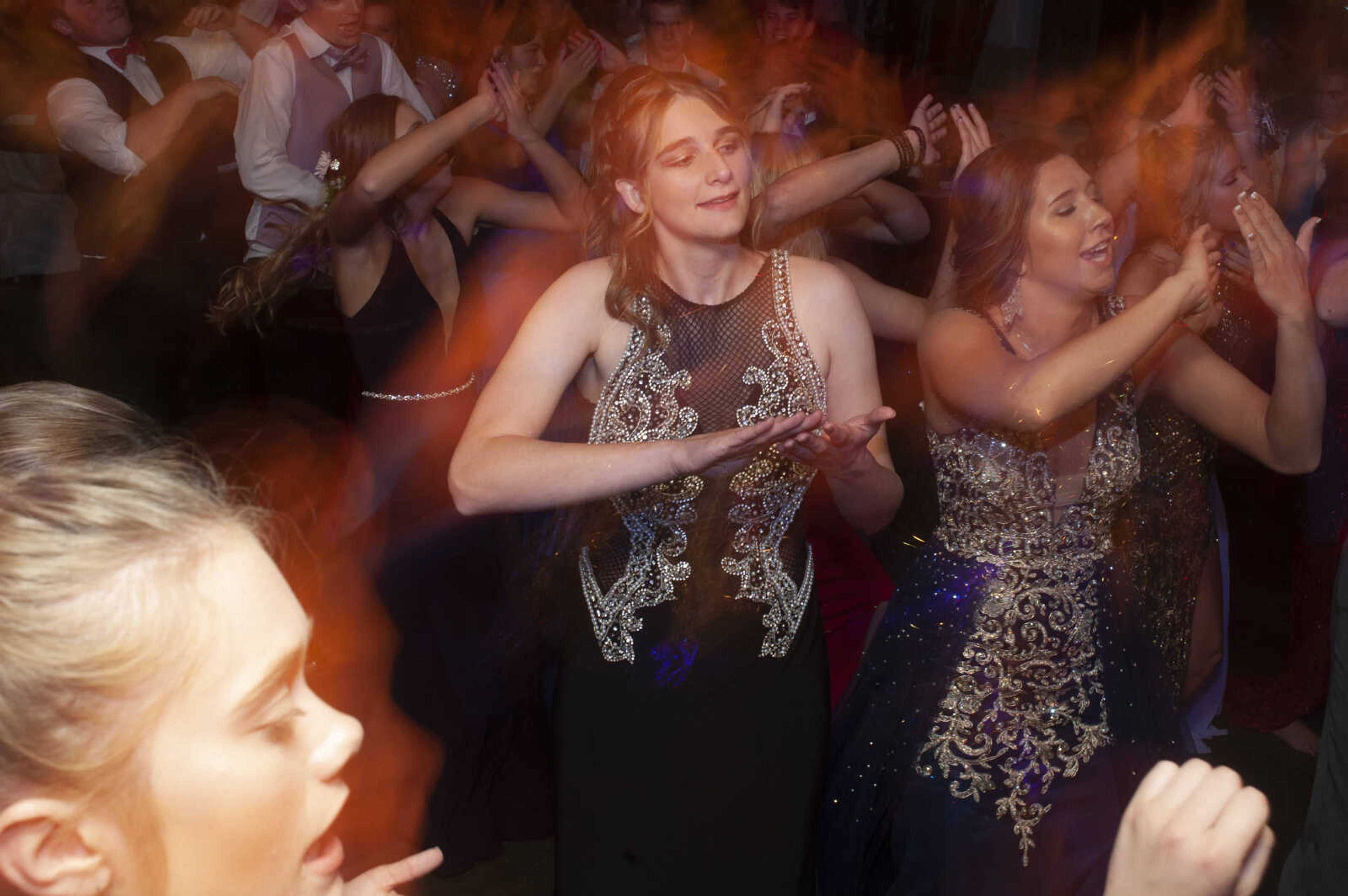 Ashley Nussbaum, center, and Leopold senior Hannah Thiele, right, dance during Leopold High School's "Masquerade at Midnight" prom Saturday, April 27, 2019, in Leopold.