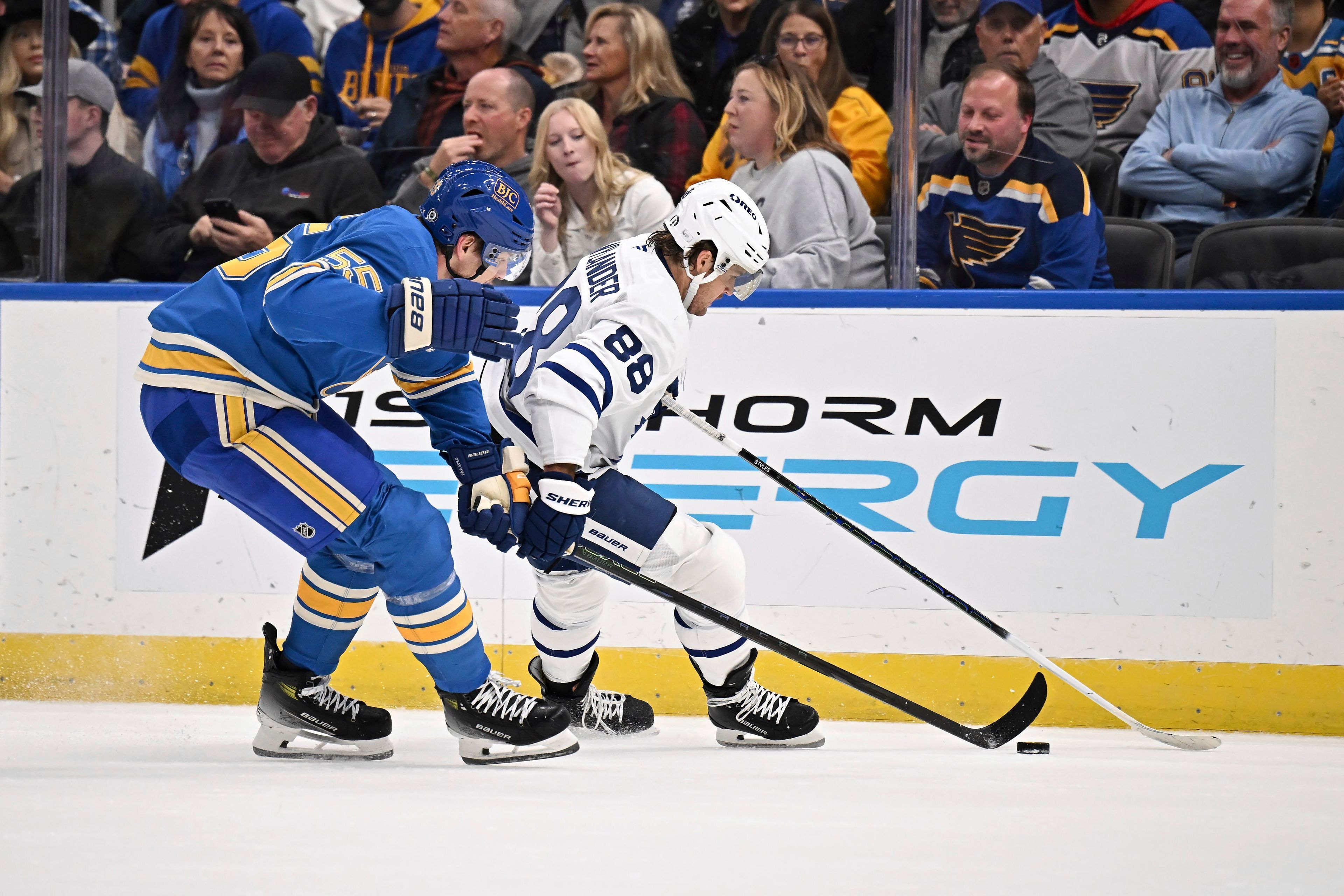 St. Louis Blues' Colton Parayko (55), left, and Toronto Maple Leafs' William Nylander (88), right, battle for a loose puck during the first period of an NHL hockey game Saturday, Nov. 2, 2024, in St. Louis. (AP Photo/Connor Hamilton)