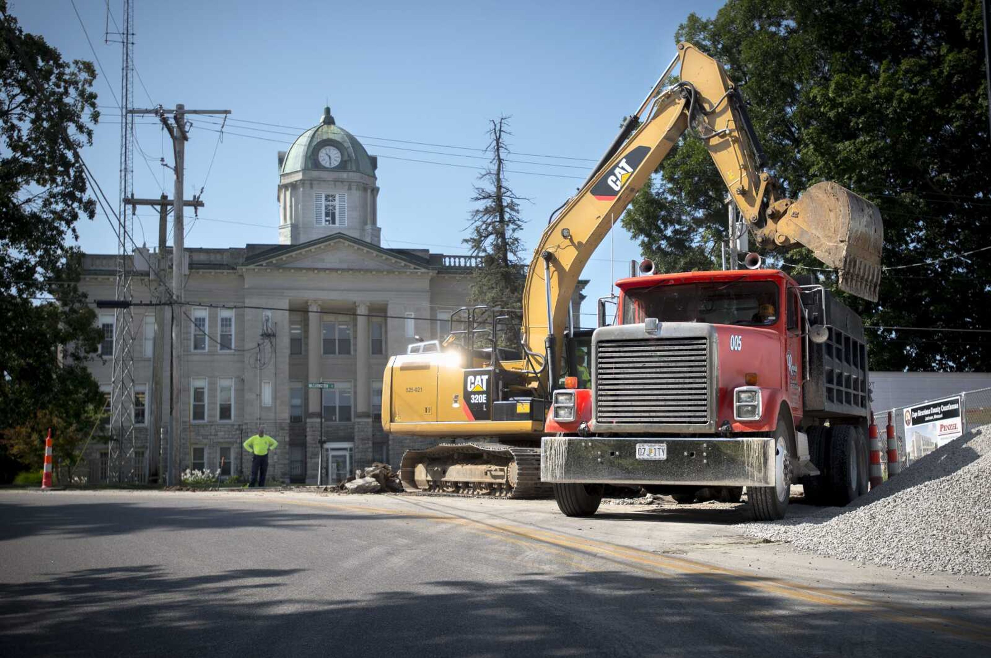 An excavator operator with Emery Sapp and Sons Inc. loads gravel in front of the Cape Girardeau County Courthouse during full-depth pavement repairs Monday at the intersection of Washington and High streets in Jackson. The southbound lane of U.S. 61 between Washington and Independence streets will reopen after this portion of the construction project is completed, which Missouri Department of Transportation engineer Brian Holt said should be by early next week. The full project, consisting of repairs from Jackson Boulevard to north of Route Y in Jackson, is expected to be completed by September.