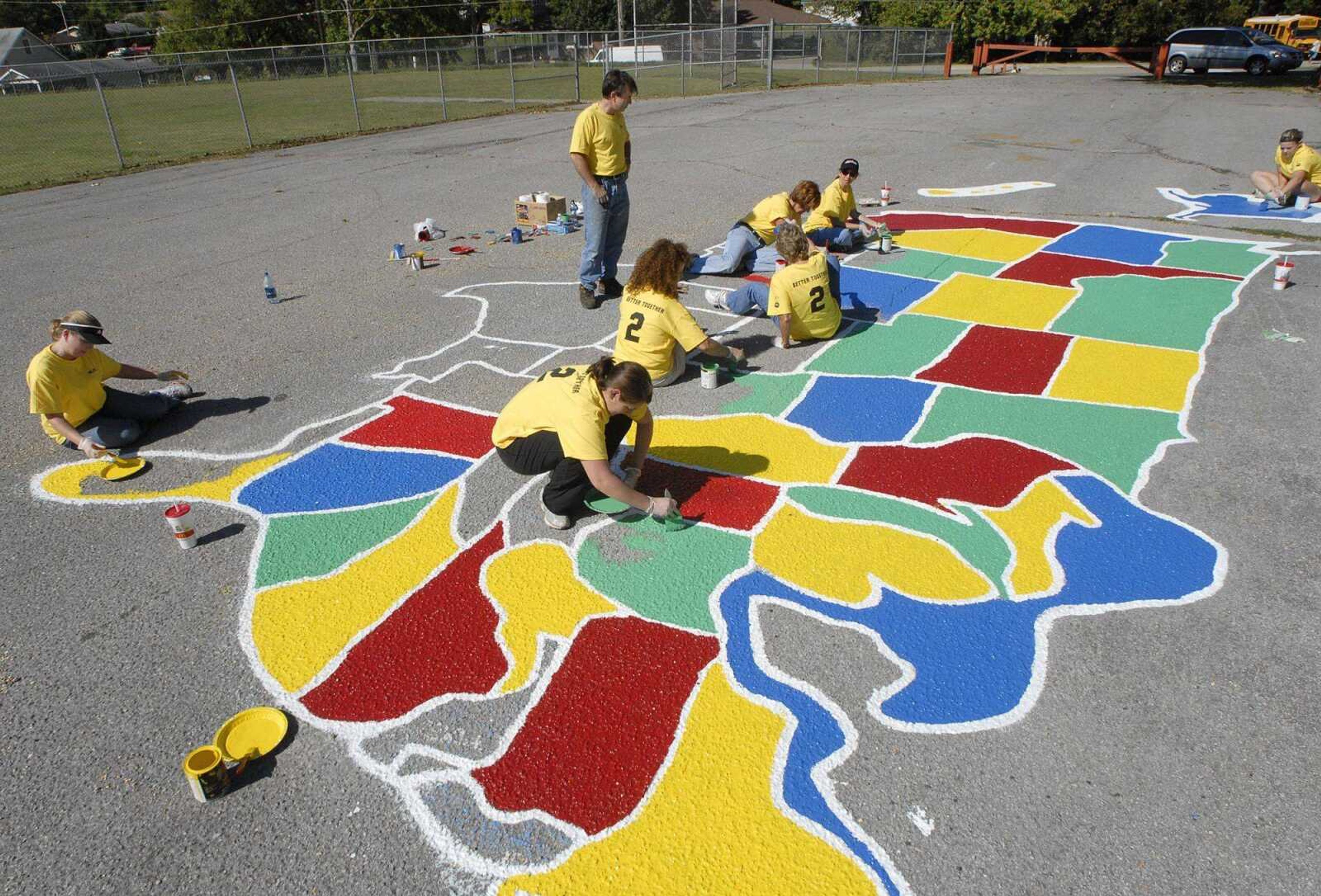 FRED LYNCH ~ flynch@semissourian.com
Jefferson Elementary School principal Mark Cook watches as service blitz volunteers repainted the U.S. map on the playground Saturday. Mostly from La Croix Church, they included Jodie Ticer, April Sterne, Lana Cook, Karen Shelby, Sharon Simmers, Julie Ray and Lauren Loftis. The map had deteriorated since it was made about five years ago.