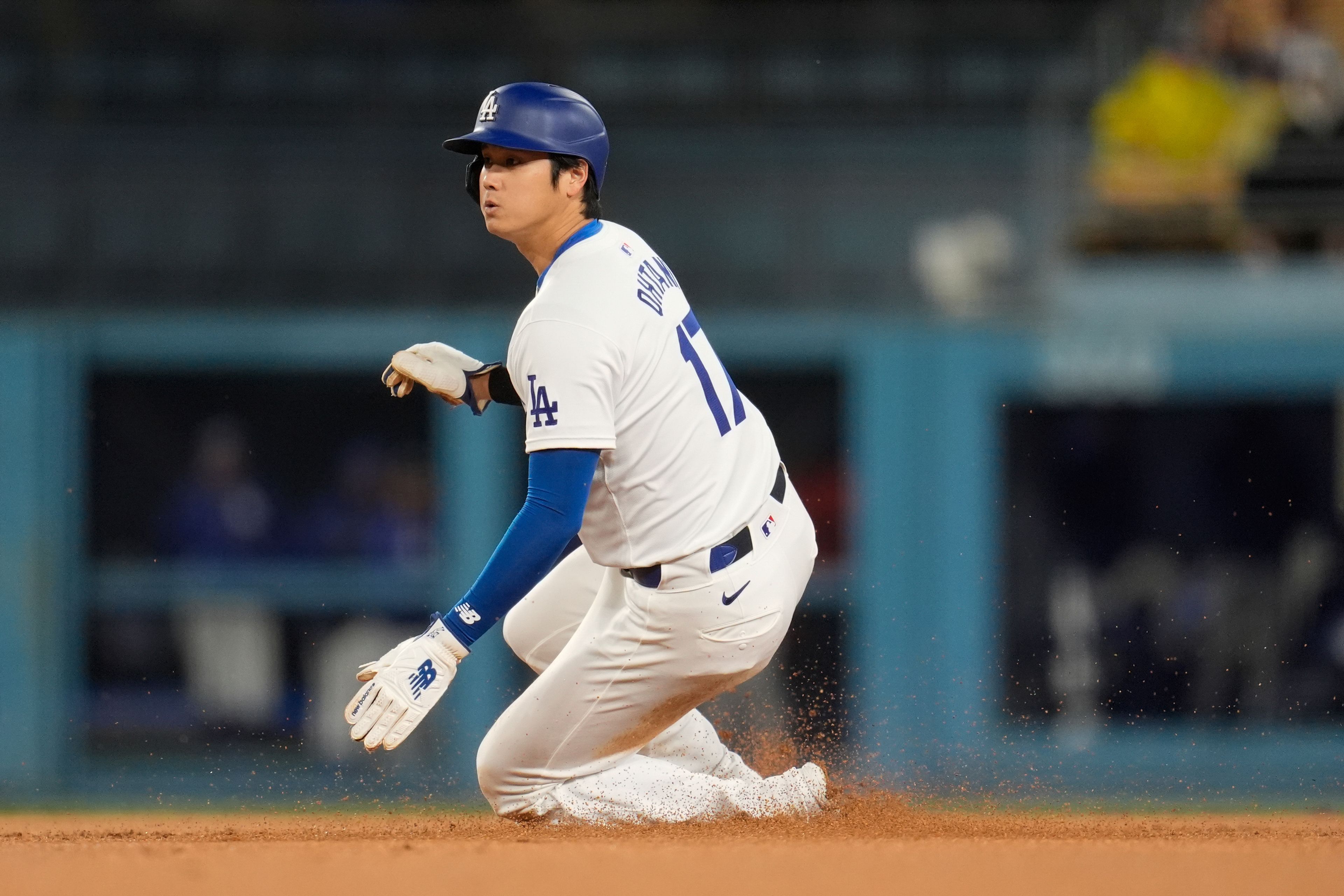 Los Angeles Dodgers' Shohei Ohtani steals second base against the San Diego Padres during the first inning of a baseball game Saturday, April 13, 2024, in Los Angeles. (AP Photo/Marcio Jose Sanchez)