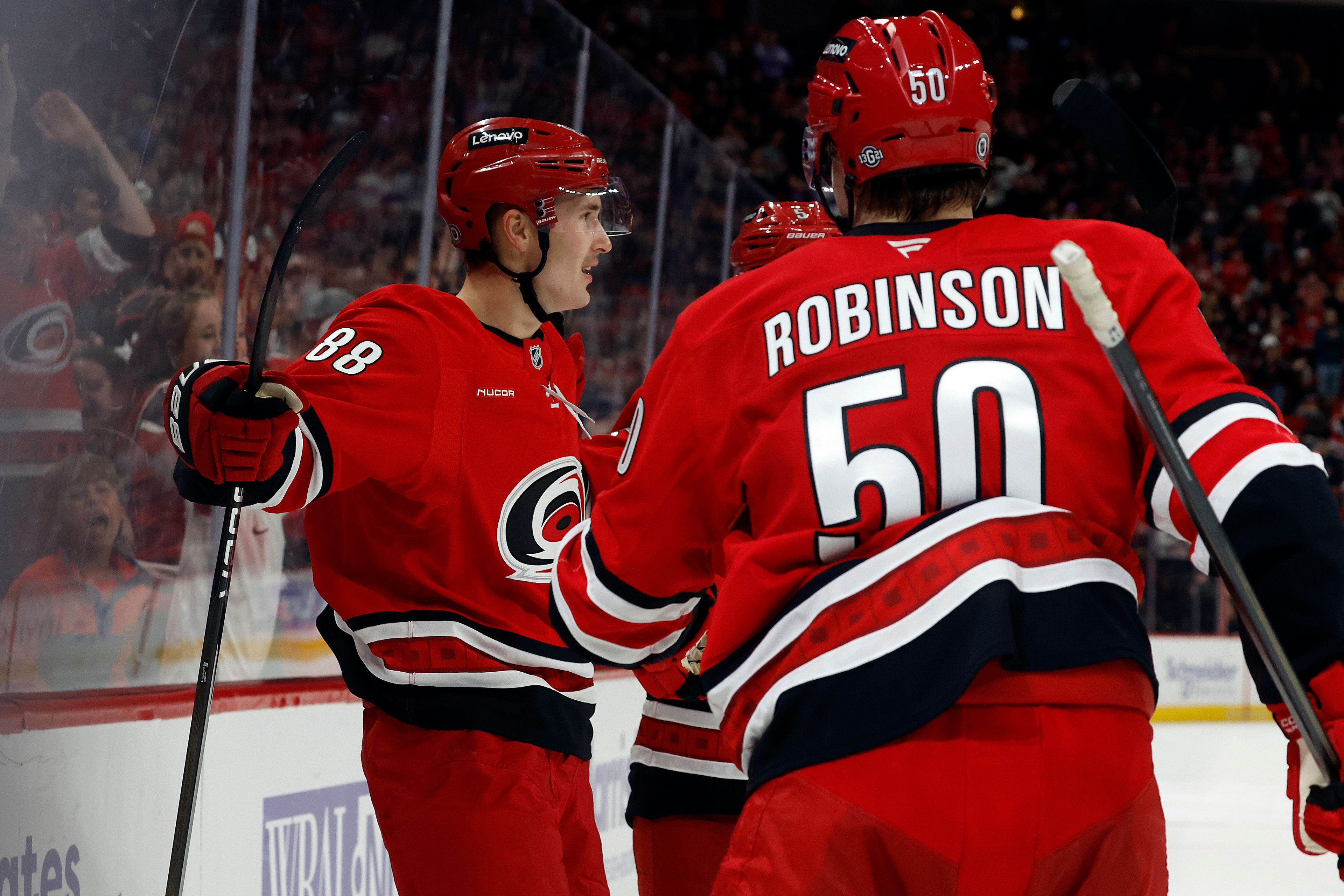 Carolina Hurricanes' Martin Necas (88) celebrates his goal with line mates Jalen Chatfield, and Eric Robinson (50) during the second period of an NHL hockey game against the St. Louis Blues in Raleigh, N.C., Sunday, Nov. 17, 2024. (AP Photo/Karl B DeBlaker)