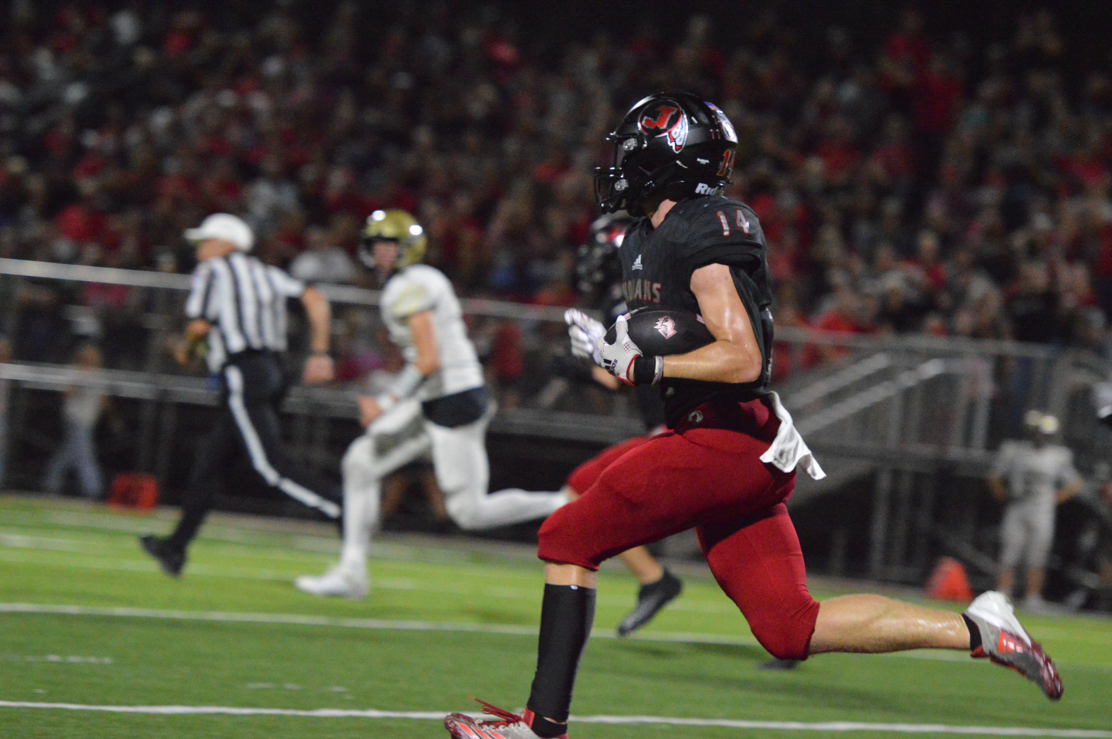 Jackson linebacker Carter Shipman returns an interception downfield into Farmington territory in the home opener on Friday, Sept. 20.