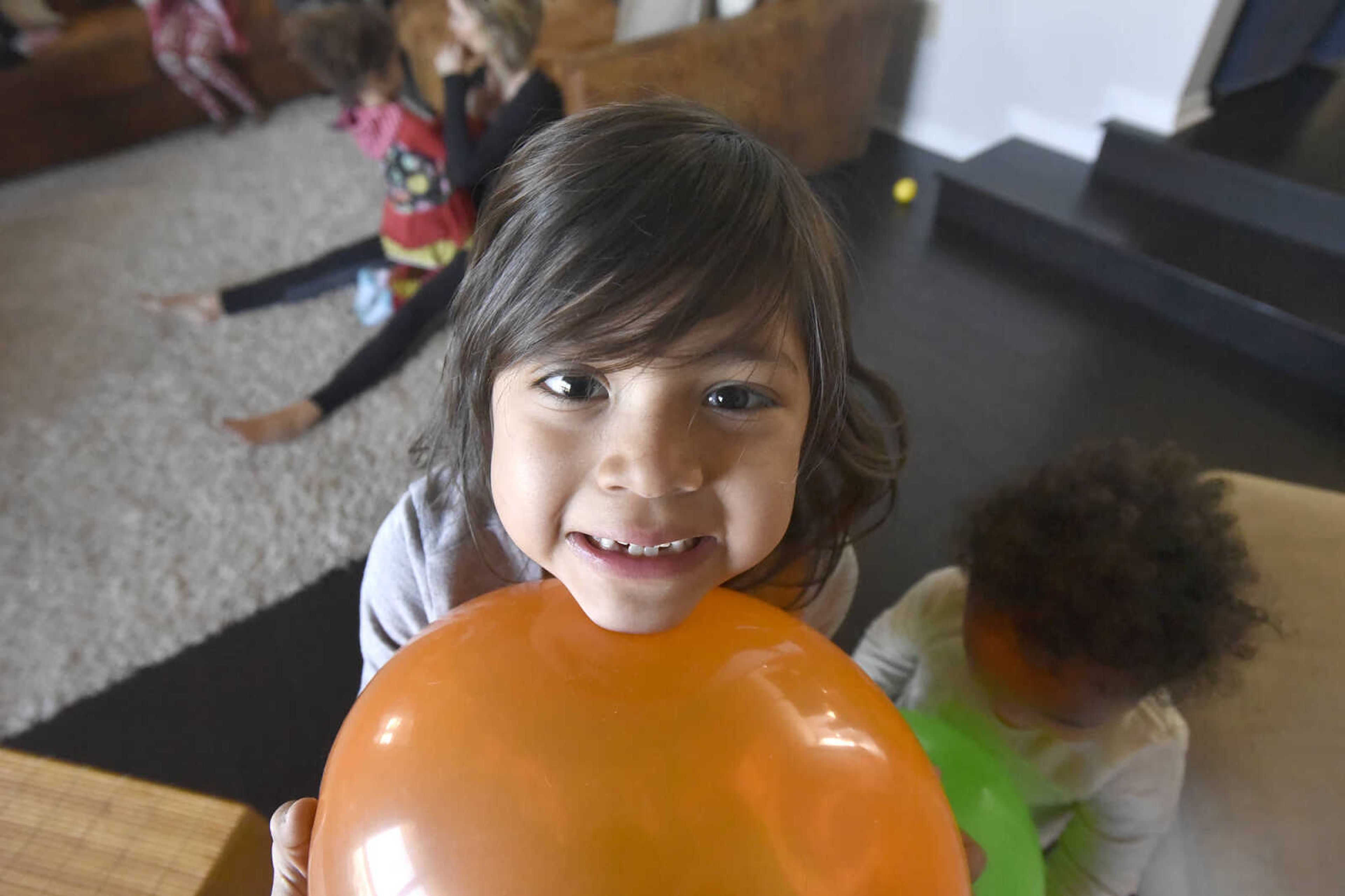 Ari Becking, 5, poses for a photo with her balloon in the family room on Saturday, Jan. 28, 2017, at the Becking's Cape Girardeau home.