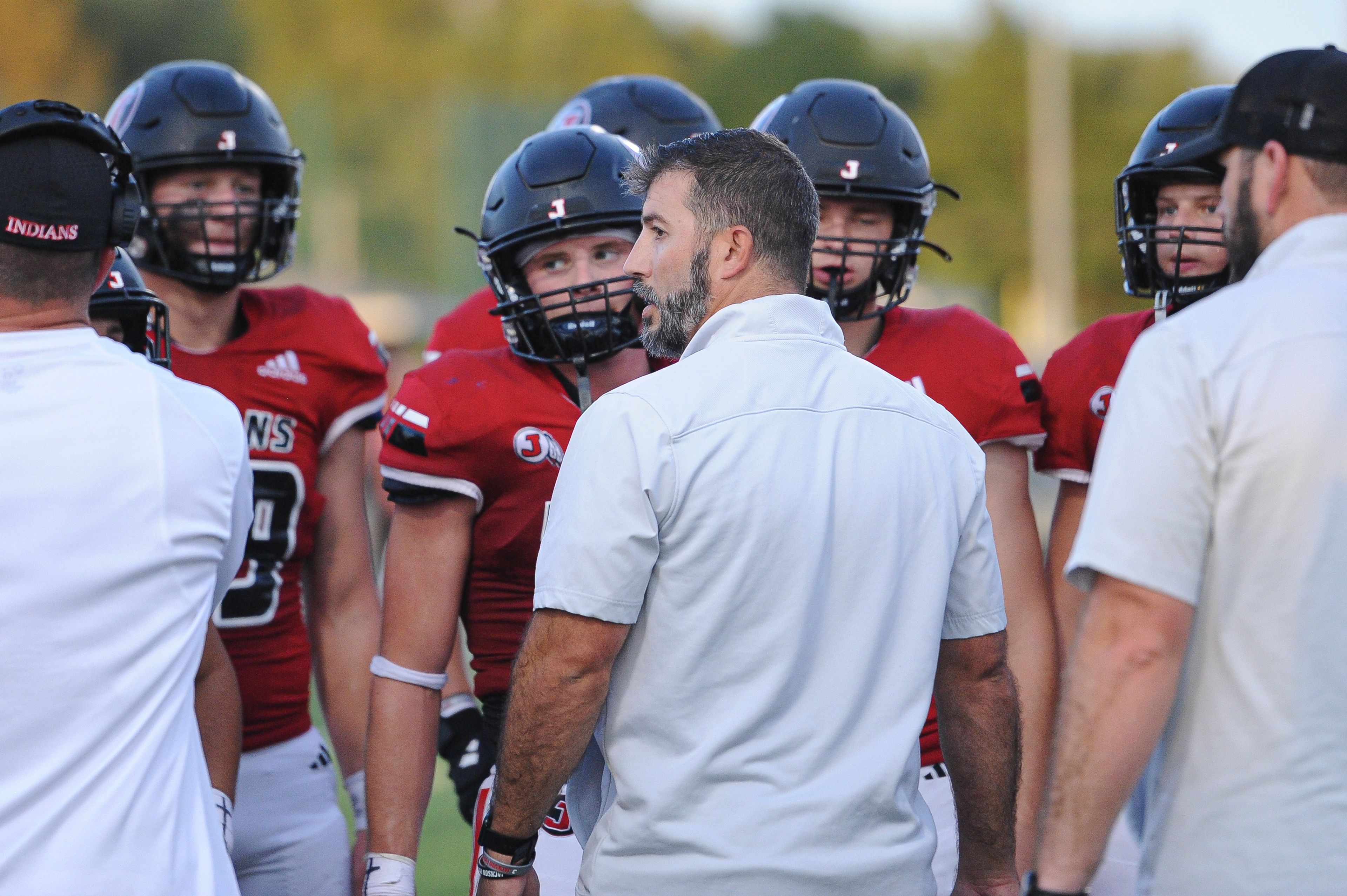 Jackson coach Ryan Nesbitt (center) talks to his team during a Saturday, September 14, 2024 game between the Edwardsville Tigers and the Jackson Indians at Edwardsville High School in Edwardsville, Ill. Edwardsville defeated Jackson, 41-7.