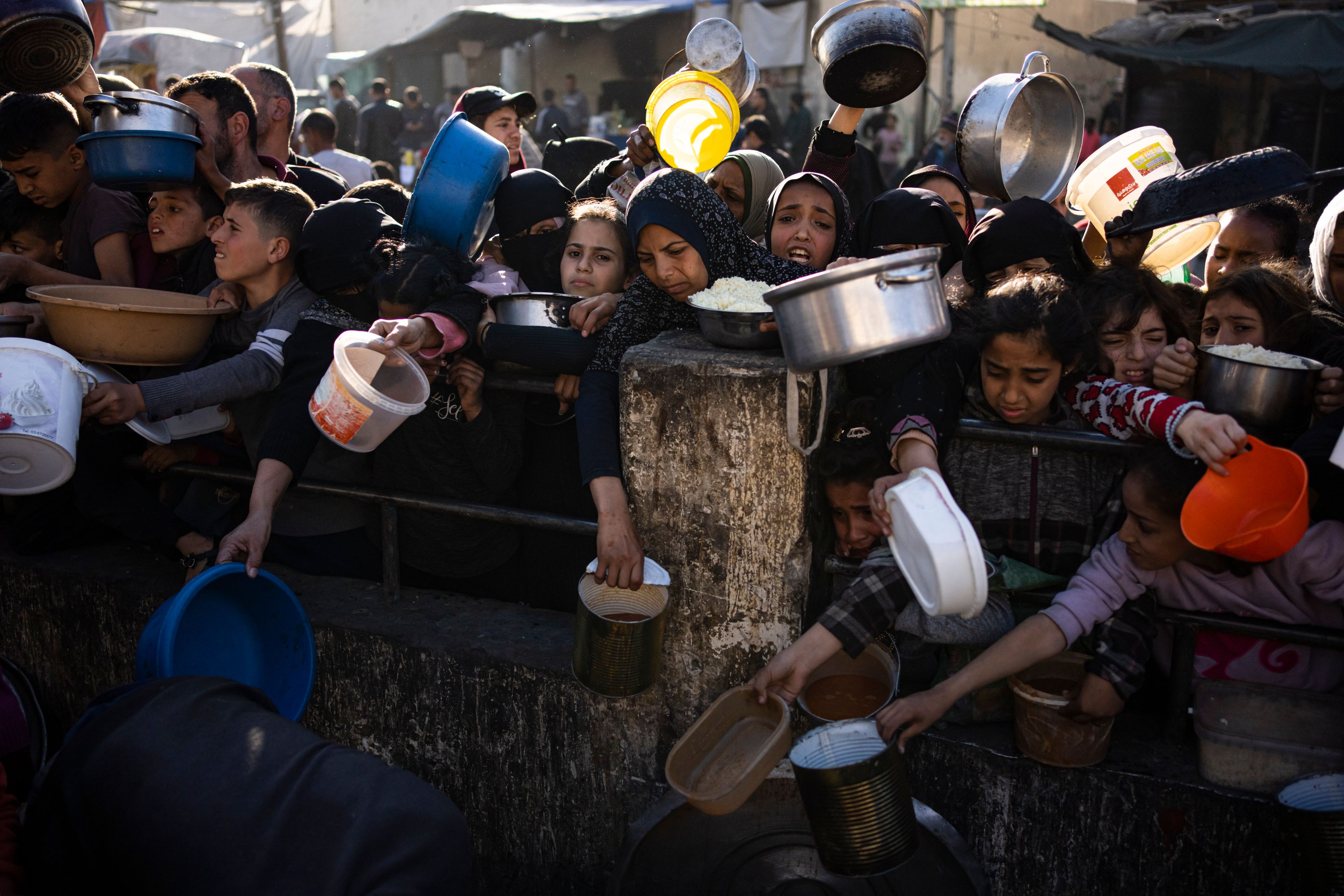 FILE - Palestinians line up for a free meal in Rafah, Gaza Strip, on March 12, 2024. (AP Photo/Fatima Shbair, File)