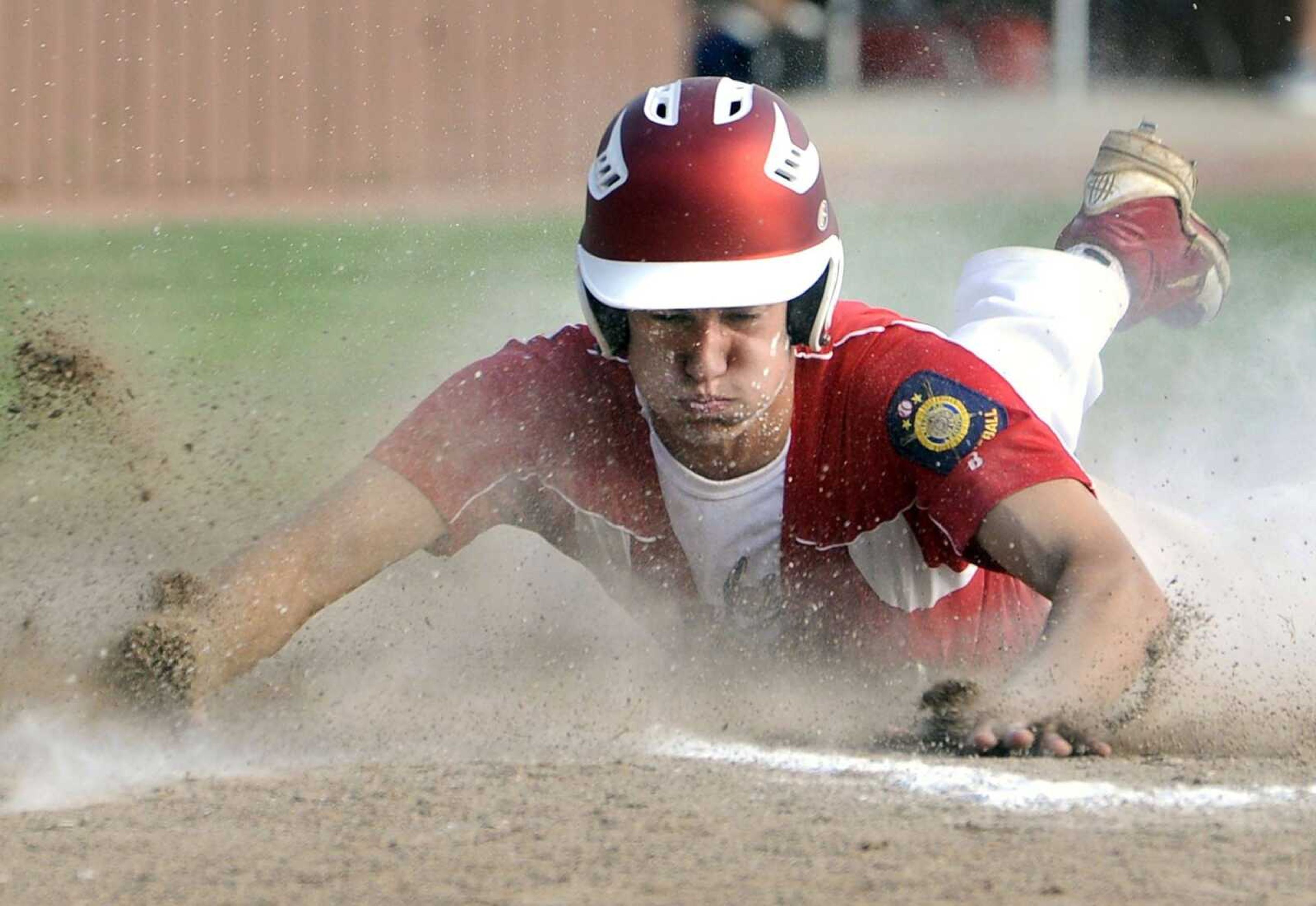 Jackson Post 158's Ryan Harvey scores on a wild pitch against Ballwin Post 611 during the second inning of the Zone 4 Senior American Legion tournament Thursday, July 23, 2015 in Farmington, Missouri. (Fred Lynch)