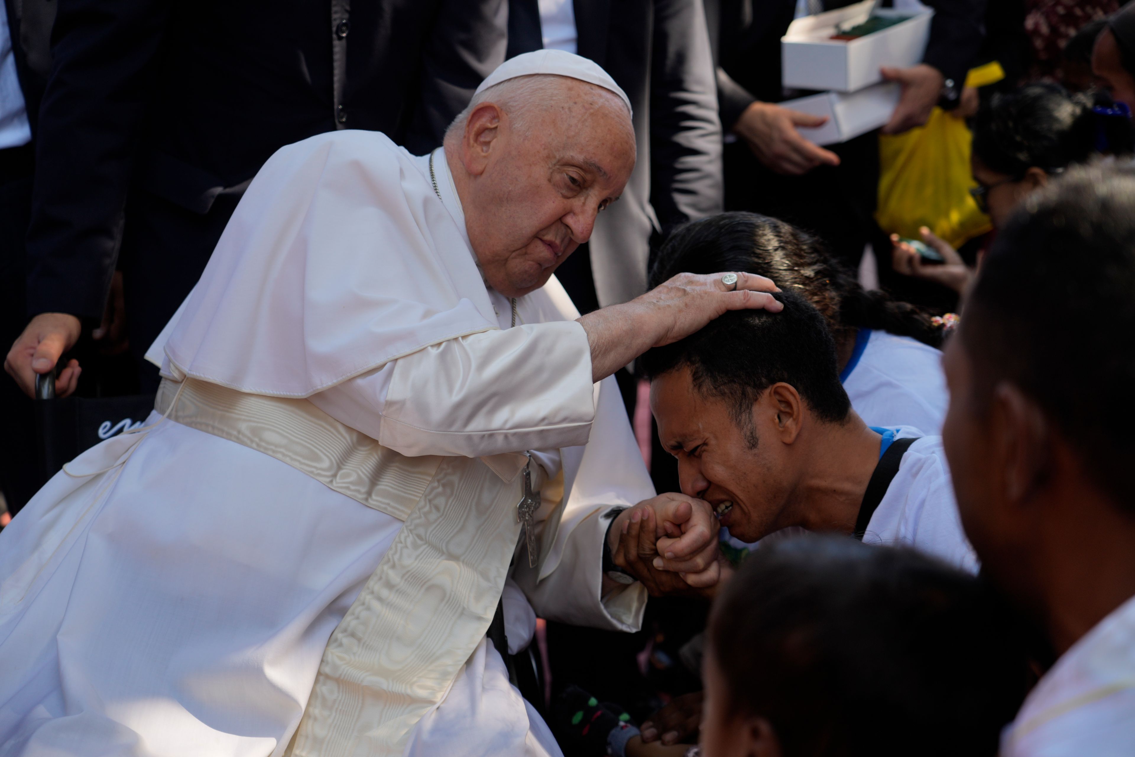 Pope Francis consoles a person during a visit at the 'Irmas ALMA' (Sisters of the Association of Lay Missionaries) School for Children with Disabilities in Dili, East Timor, Tuesday, Sept. 10, 2024. Pope Francis has indirectly acknowledged the abuse scandal in East Timor involving its Nobel Peace Prize-winning independence hero Bishop Carlos Filipe Ximenes Belo. (AP Photo/Gregorio Borgia)