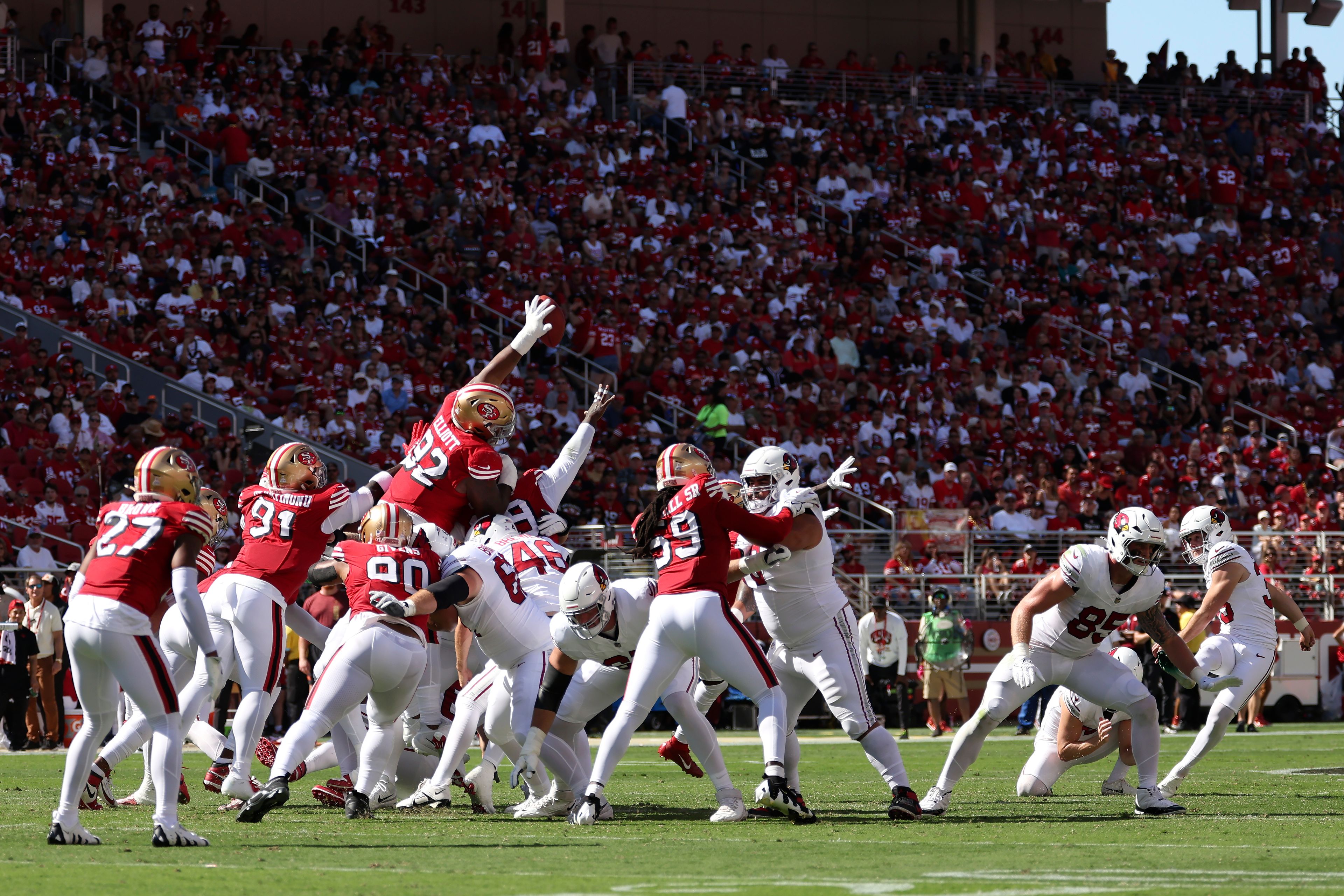 San Francisco 49ers' Jordan Elliott (92) blocks a field goal attempt by Arizona Cardinals place kicker Chad Ryland, right, that 49ers' Deommodore Lenoir returned for a touchdown during the first half of an NFL football game in Santa Clara, Calif., Sunday, Oct. 6, 2024. (AP Photo/Jed Jacobsohn)