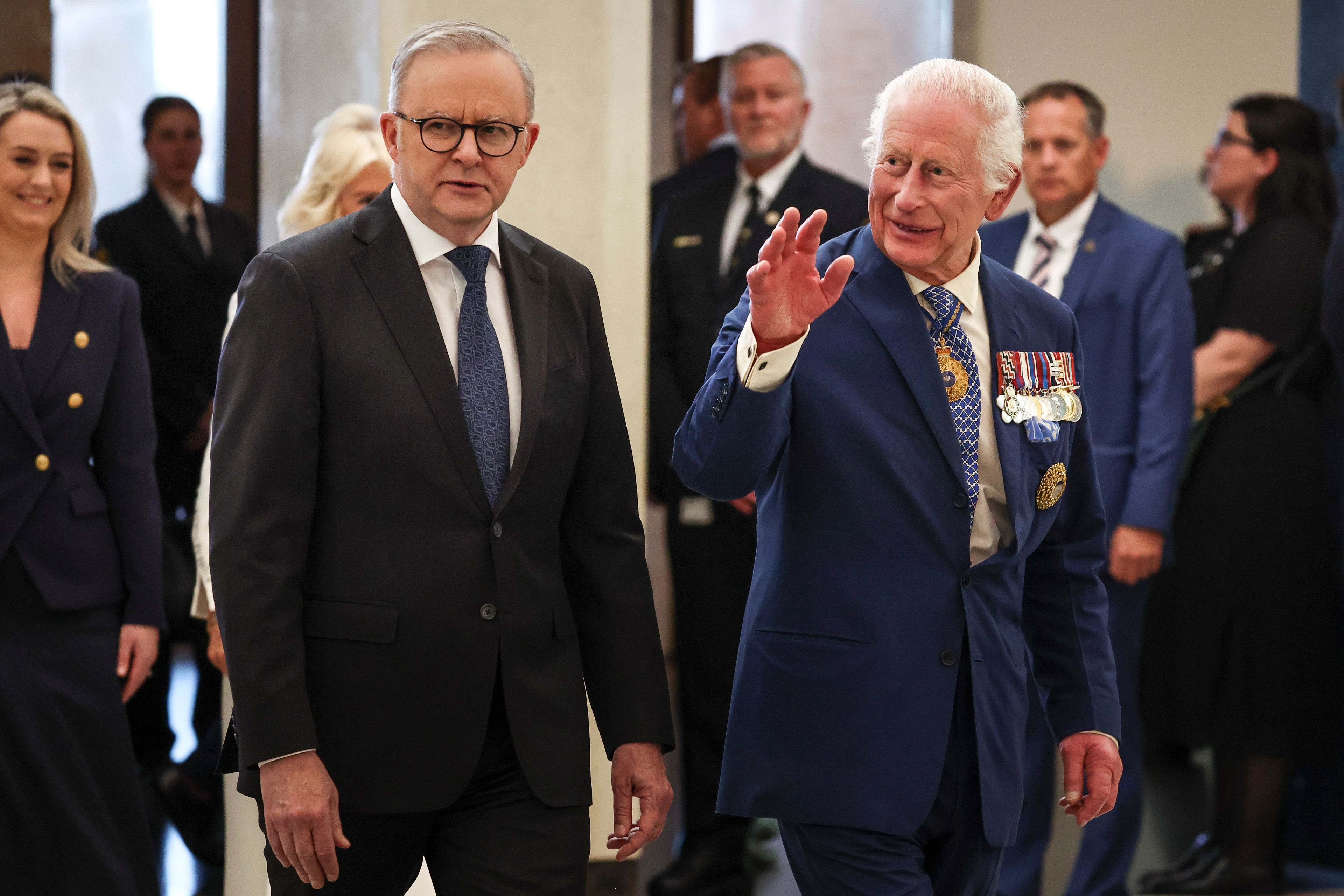 Britain's King Charles III, right, waves beside Australia's Prime Minister Anthony Albanese as they enter Parliament House in Canberra , Australia, Monday, Oct. 21, 2024. (David Gray/Pool Photo via AP)