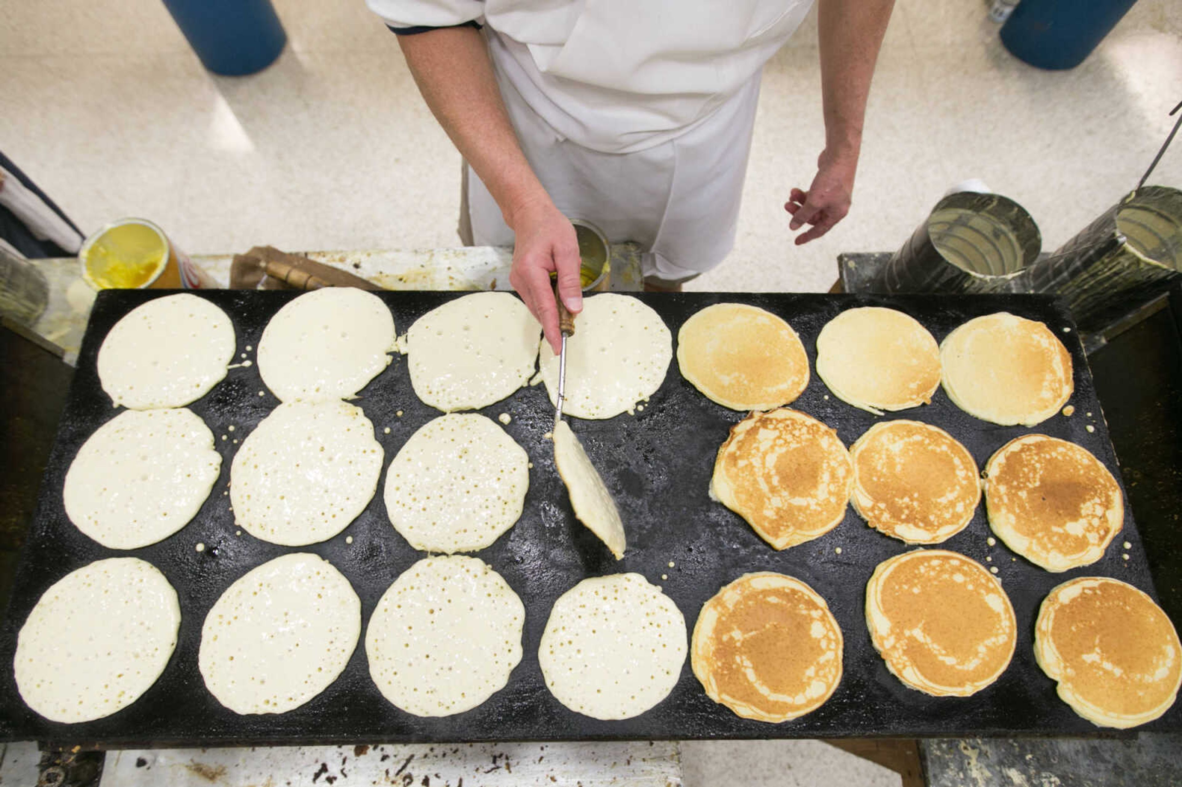 GLENN LANDBERG ~ glandberg@semissourian.com

Luke Landgraf flips a batch of pancakes during the 78th annual Noon Lions Club Pancake Day Wednesday, March 9, 2016 at the Arena Building in Cape Girardeau.