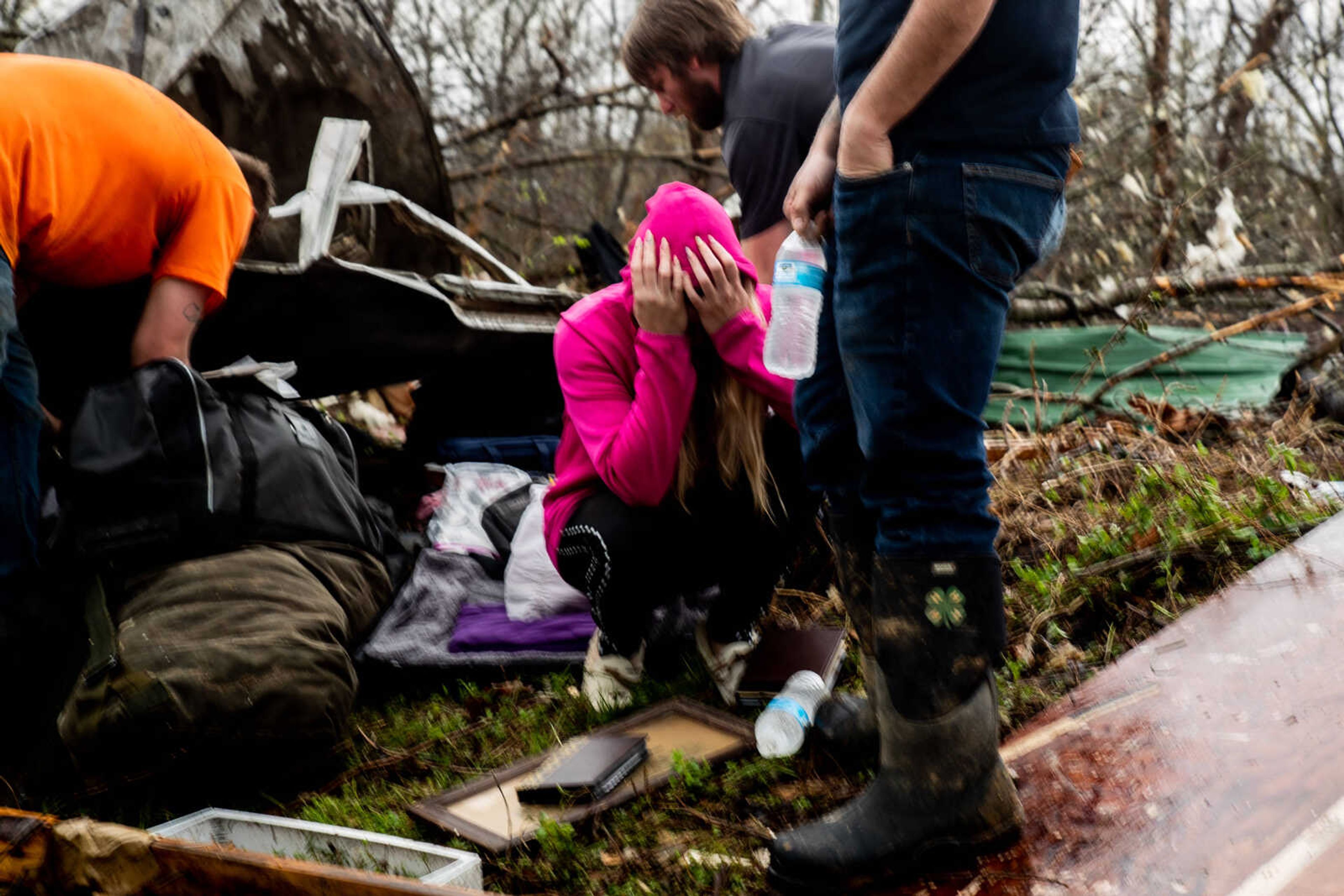 Holly Shipley breaks down in tears as she attempts to gather belongings from the rubble of a mobile home where five of her family members died in a tornado on Wednesday, April 5 in Glen Allen.