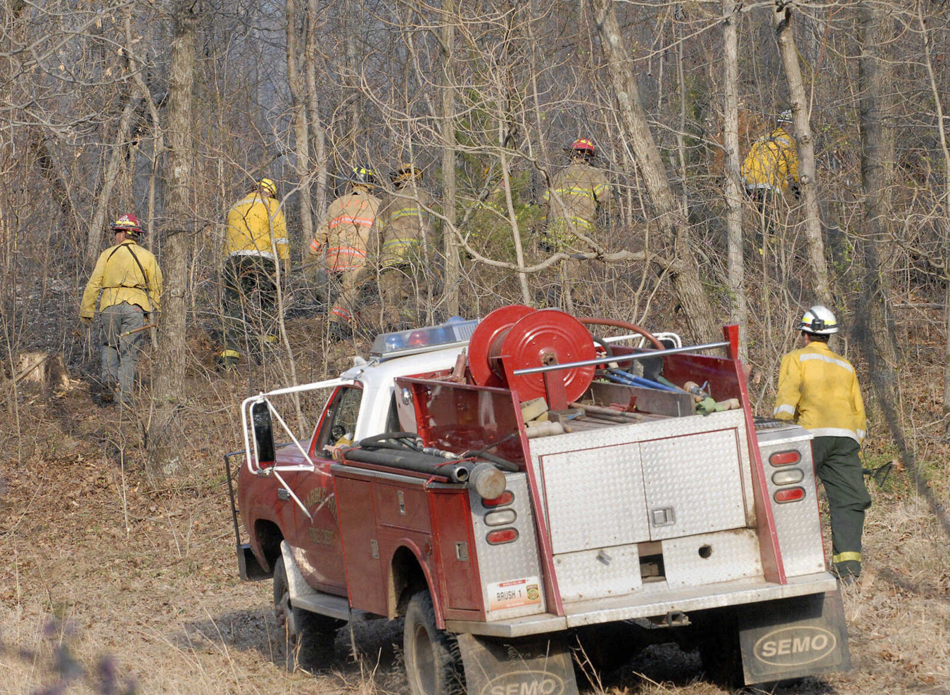 LAURA SIMON~lsimon@semissourian.com
Firefighters head into the woods to battle a natural cover fire off of Cissus Lane near Neelys Landing Sunday, April 3, 2011. Firefighters from Cape Girardeau, Perry, Scott, and Bollinger Counties contained the blaze that ravaged 50 acres of land.