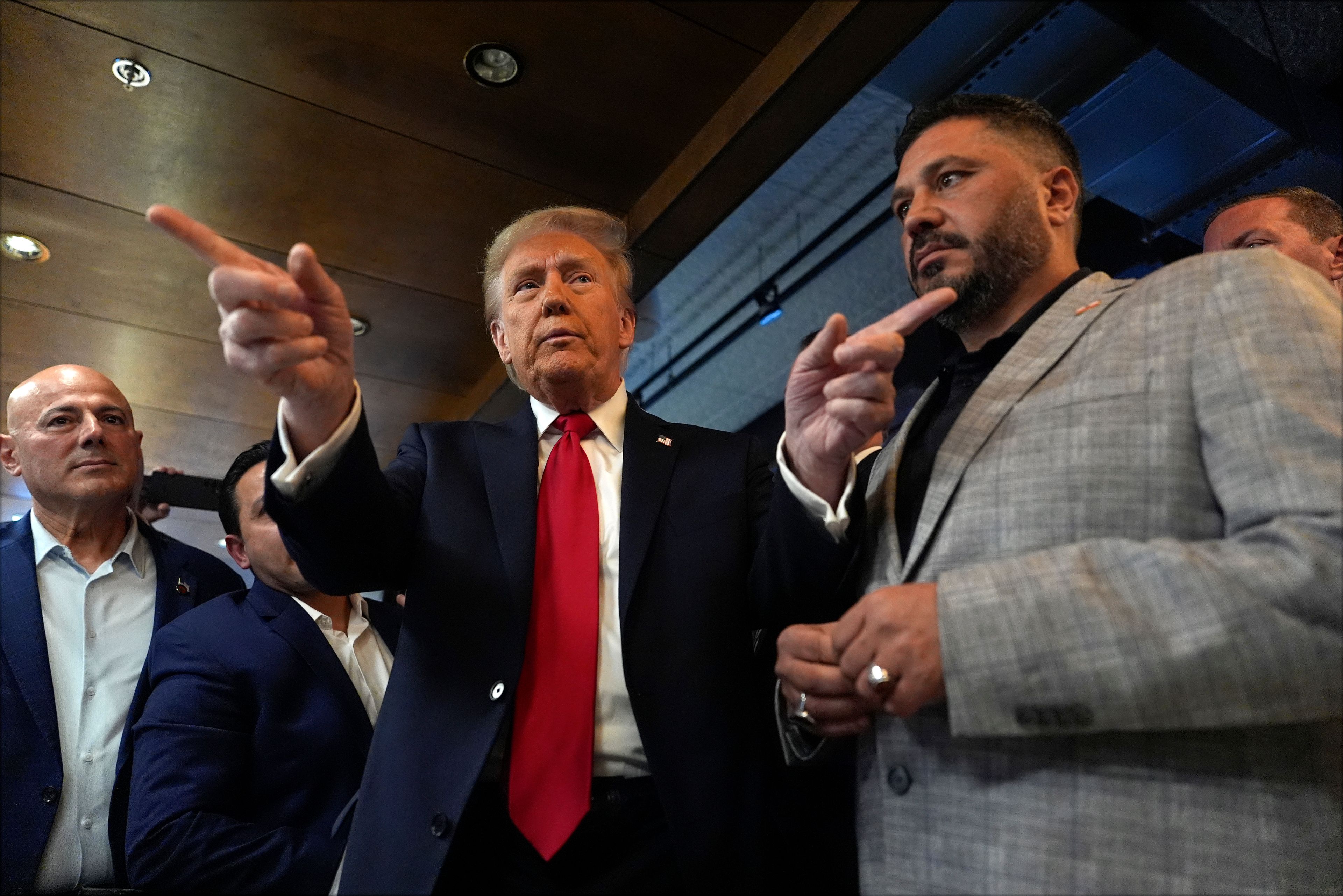 Republican presidential nominee former President Donald Trump talks as owner Albert Abbas, right, listens during a visit to The Great Commoner, Friday, Nov. 1, 2024, in Dearborn, Mich. (AP Photo/Julia Demaree Nikhinson)