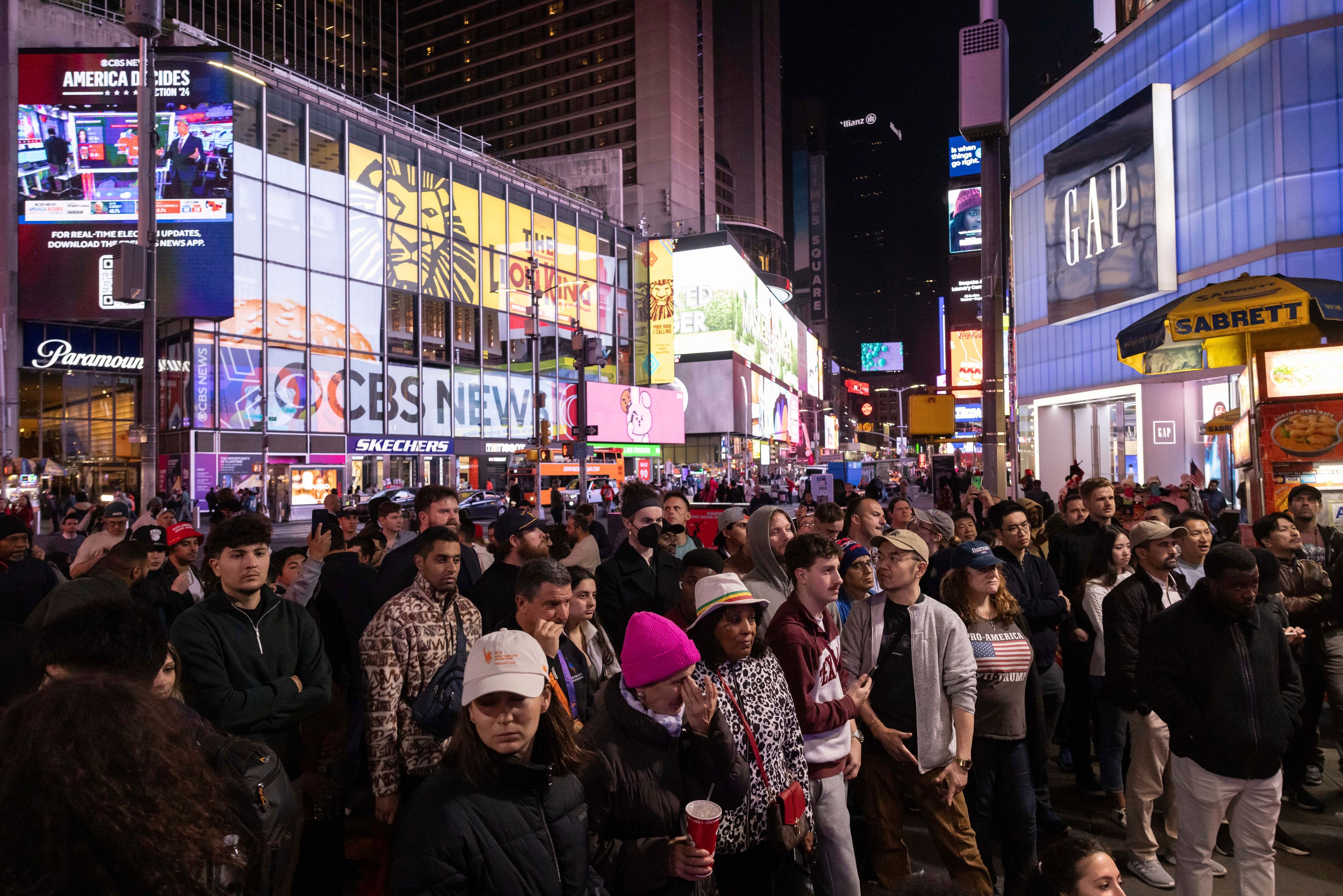 People watch an ABC News livestream showing poll results in Times Square in New York, Wednesday, Nov. 6, 2024. (AP Photo/Yuki Iwamura)