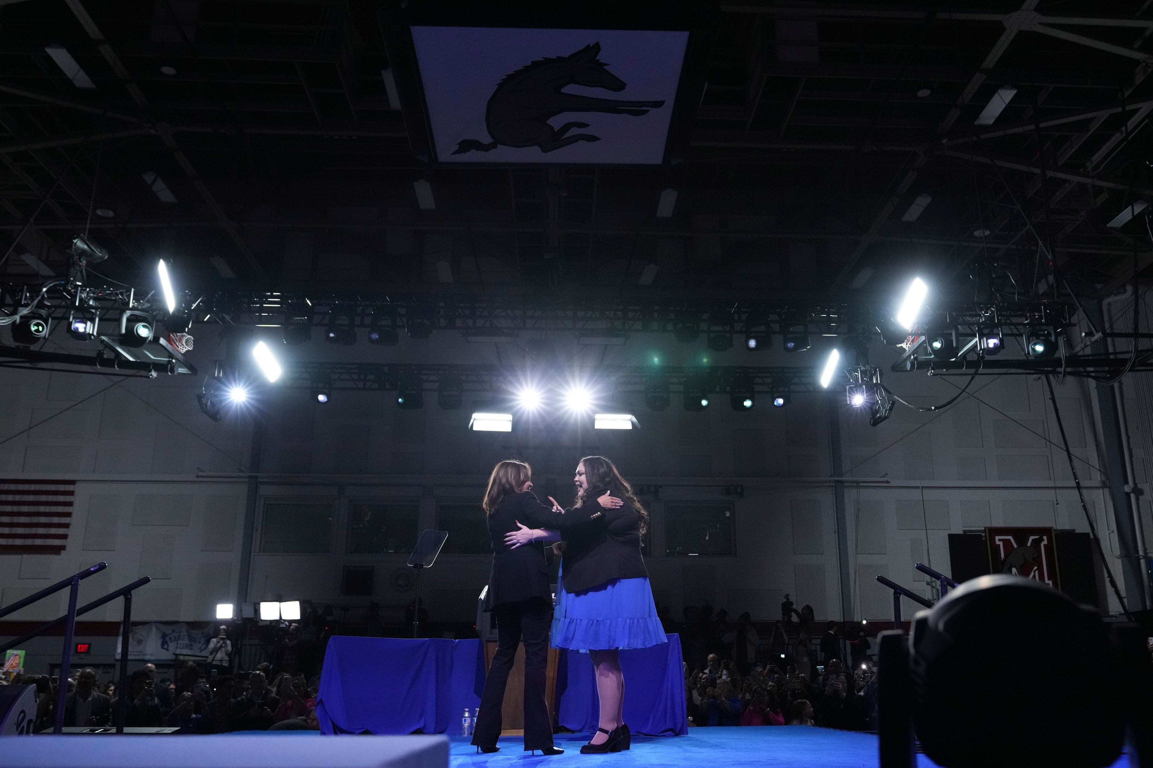 Small business owner Elizabeth Strong, right, hugs Democratic presidential nominee Vice President Kamala Harris on stage during a campaign rally in Memorial Hall at Muhlenberg College in Allentown, Pa., Monday, Nov. 4, 2024. (AP Photo/Jacquelyn Martin)