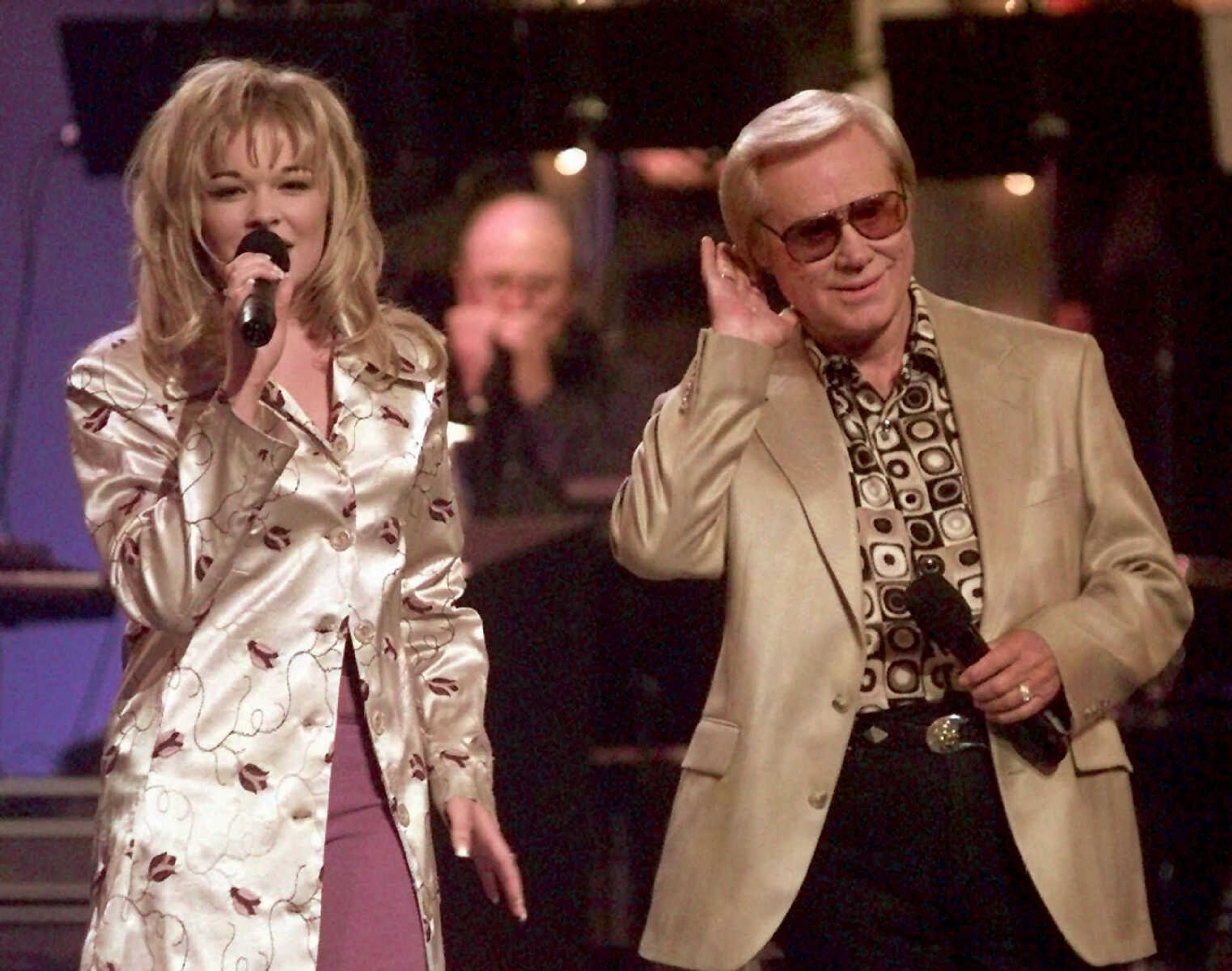 FILE - In this June 16, 1997 file photo, Country music veteran George Jones bends an ear toward 14-year-old newcomer LeAnn Rimes during the opening segment of the TNN-Music City News Country Awards show in Nashville, Tenn.,  Jones, the peerless, hard-living country singer who recorded dozens of hits about good times and regrets and peaked with the heartbreaking classic "He Stopped Loving Her Today," has died. He was 81. Jones died Friday, April 26, 2013 at Vanderbilt University Medical Center in Nashville after being hospitalized with fever and irregular blood pressure, according to his publicist Kirt Webster. (AP Photo/Mark Humphrey, file)