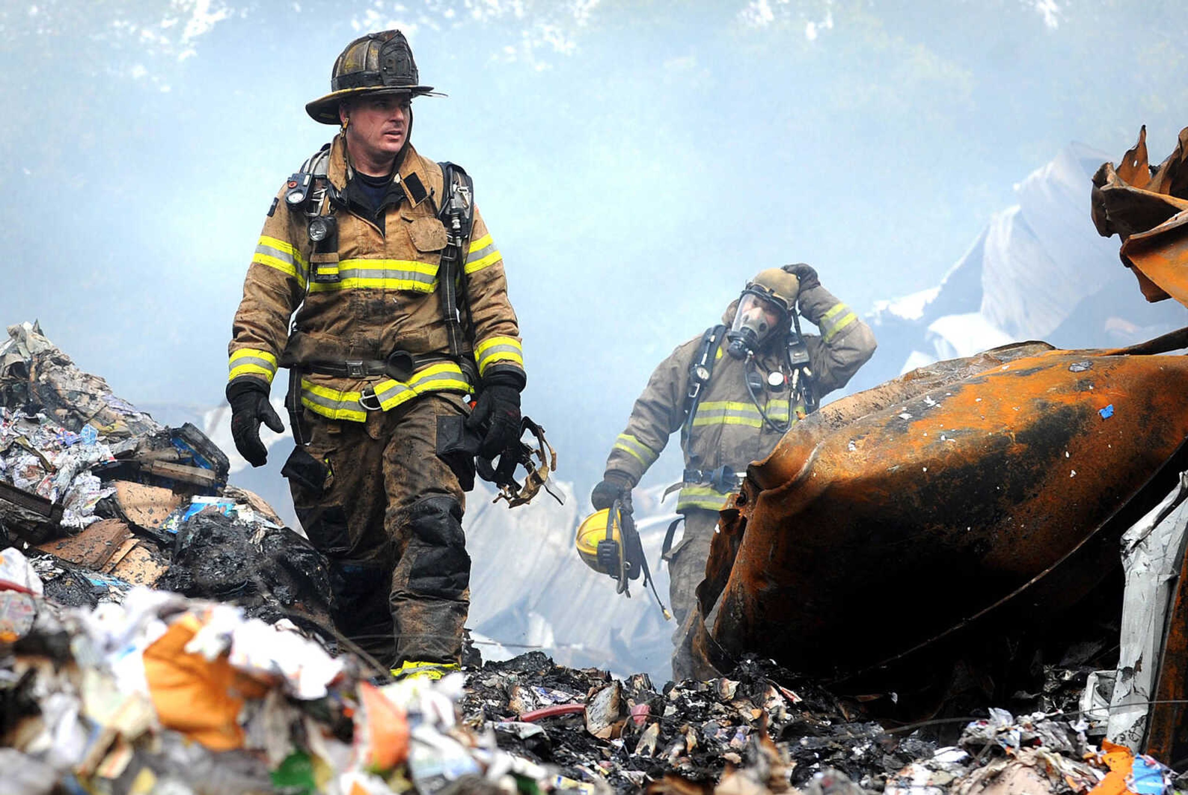 LAURA SIMON ~ lsimon@semissourian.com

Andrew Juden with the Cape Girardeau Fire Department, left, and David Goehman with the East County Fire Protection District walk through the smoldering ruble of the Missouri Plastics plant Friday morning, Oct. 4, 2013, in Jackson. The approximately 100,00-square-foot recycling plant caught fire around 10 p.m. Thursday. Every fire department in Cape Girardeau County was dispatched to battle the blaze.