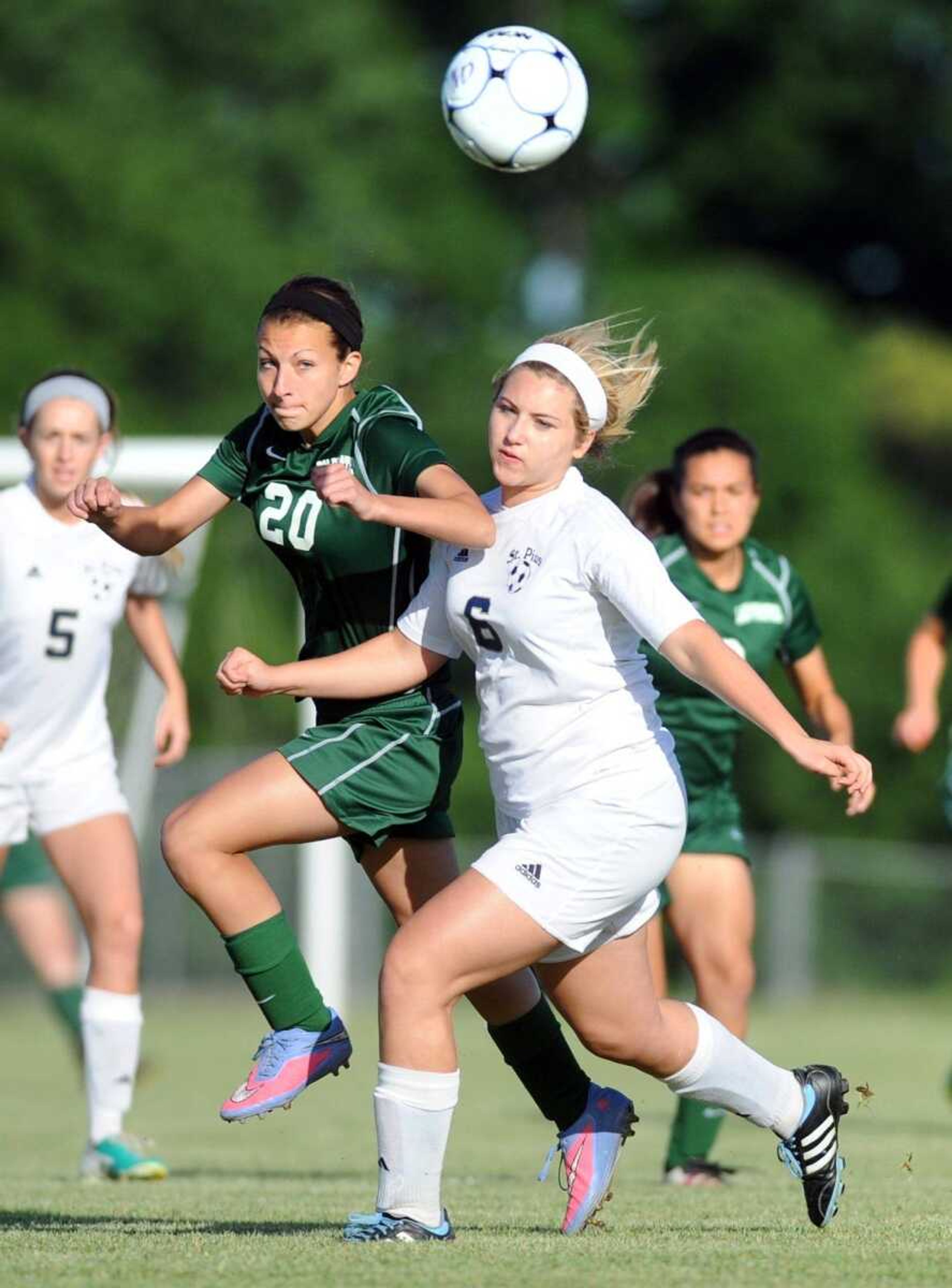 Perryville's Kylie Bilek, left, races St. Pius' Sarah Parker to the ball in the first half of the Class 2 District 1 championship game, Tuesday, May 19, 2015, in Cape Girardeau. St. Pius won 3-0. (Laura Simon)