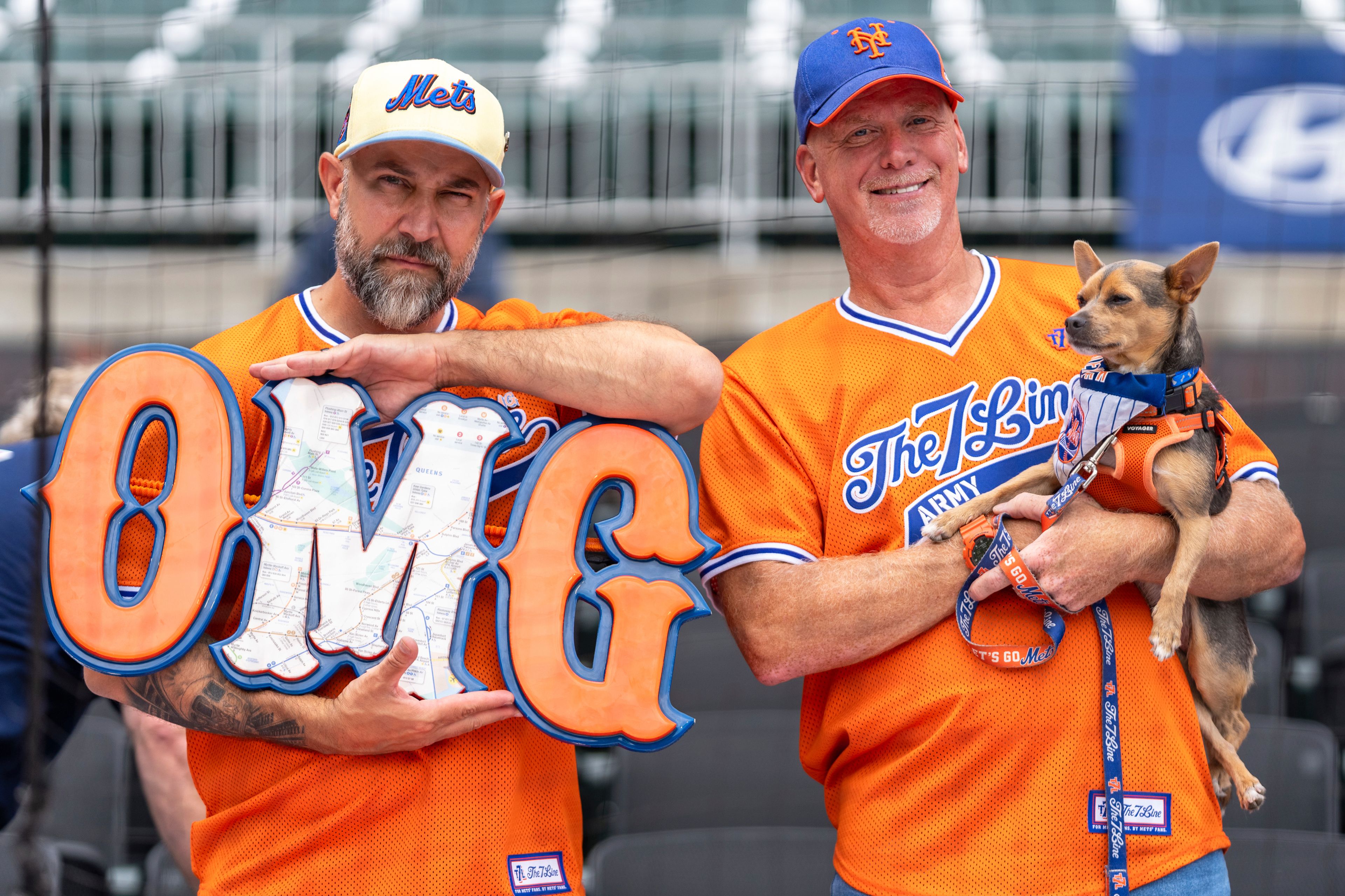 New York Mets fans await their turn to get autographs before the start of a baseball game against the Atlanta Braves, Monday, Sept. 30, 2024, in Atlanta. (AP Photo/Jason Allen)