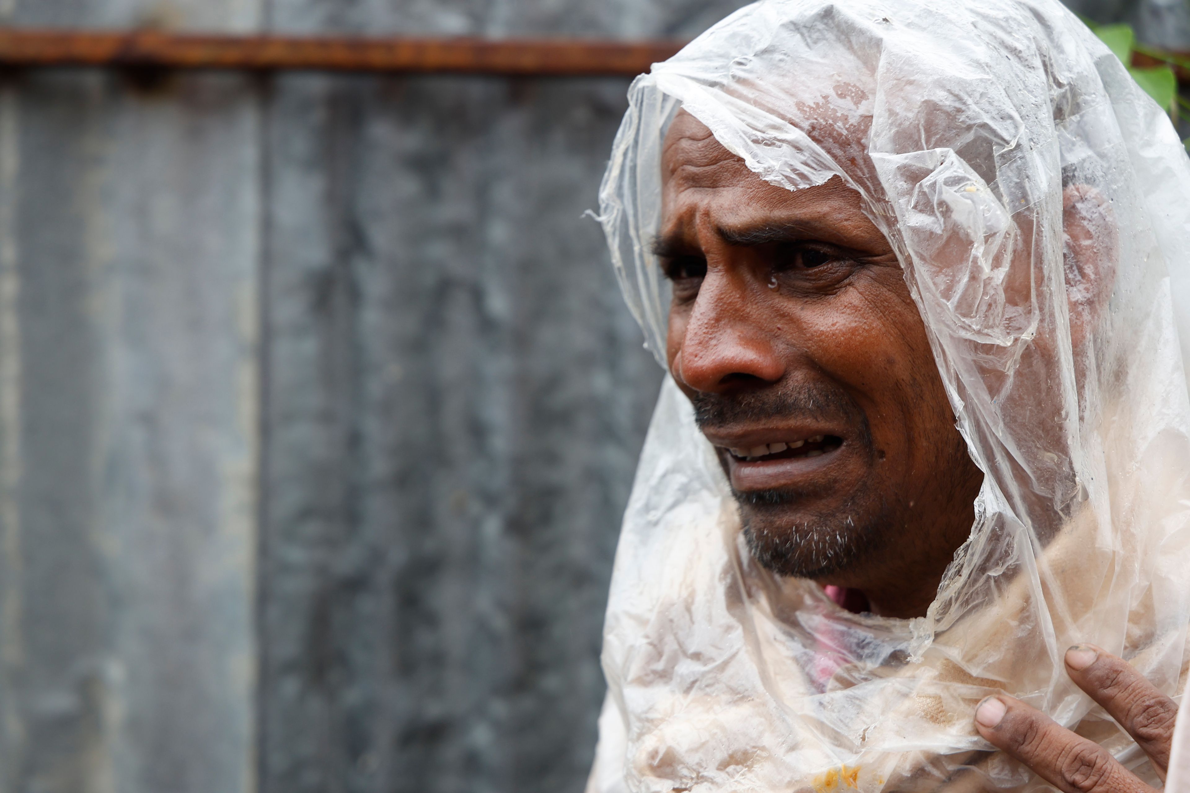 Hridesh Sah, 40, mourns the death of his nephew, who was found dead near a scrap collection site on the outskirts of Kathmandu after the shed he was sleeping under was flooded due to heavy rains in the country's capital, Nepal, Saturday, Sept. 28, 2024. (AP Photo/Gopen Rai)