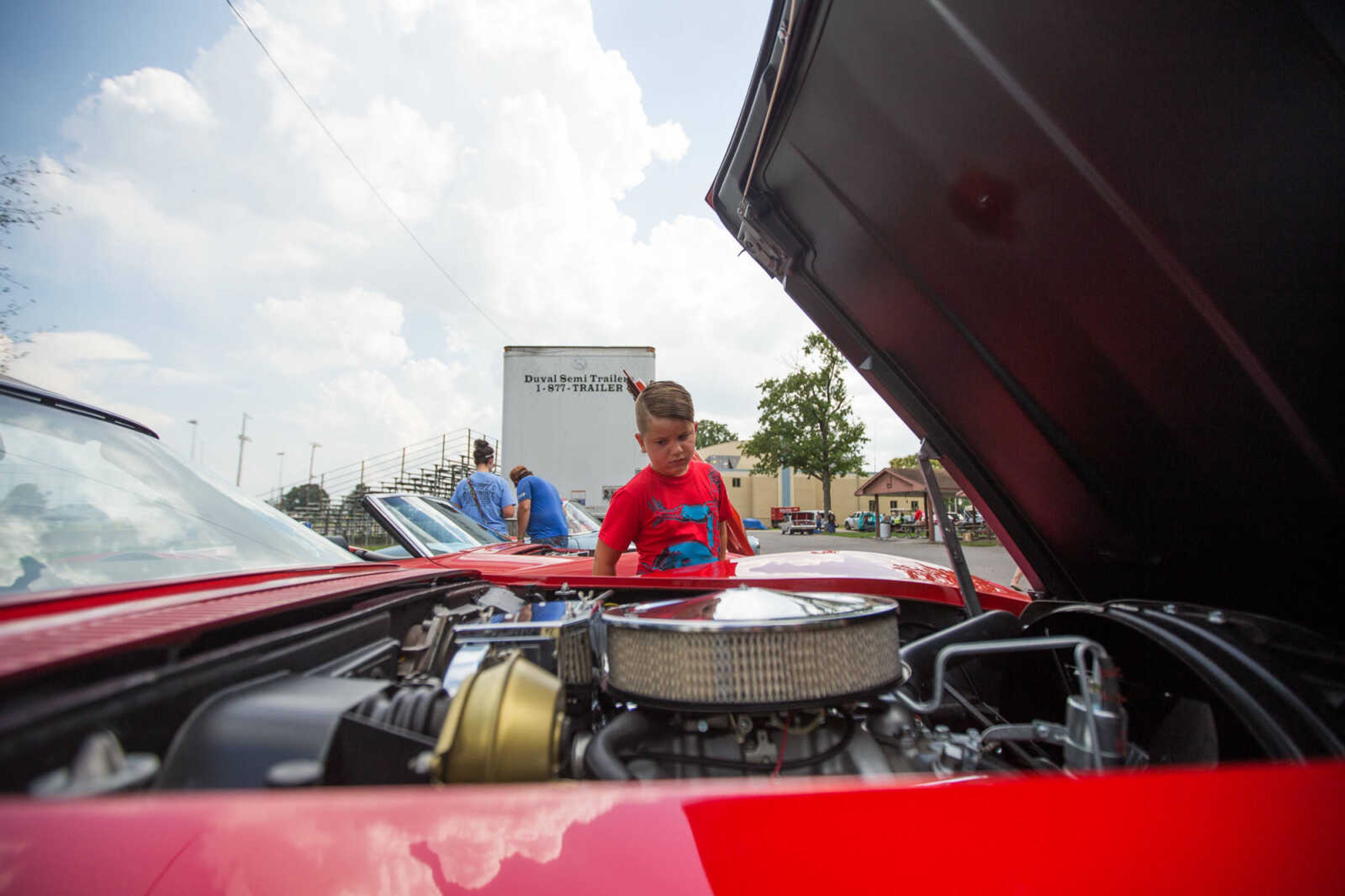 GLENN LANDBERG ~ glandberg@semissourian.com

Brody Simpher gets a look under the hood of a 1968 Chevrolet Corvettes during the Rev'n Rods & Heartland Music Tour stop at Arena Park Tuesday, July 19, 2016 in Cape Girardeau.