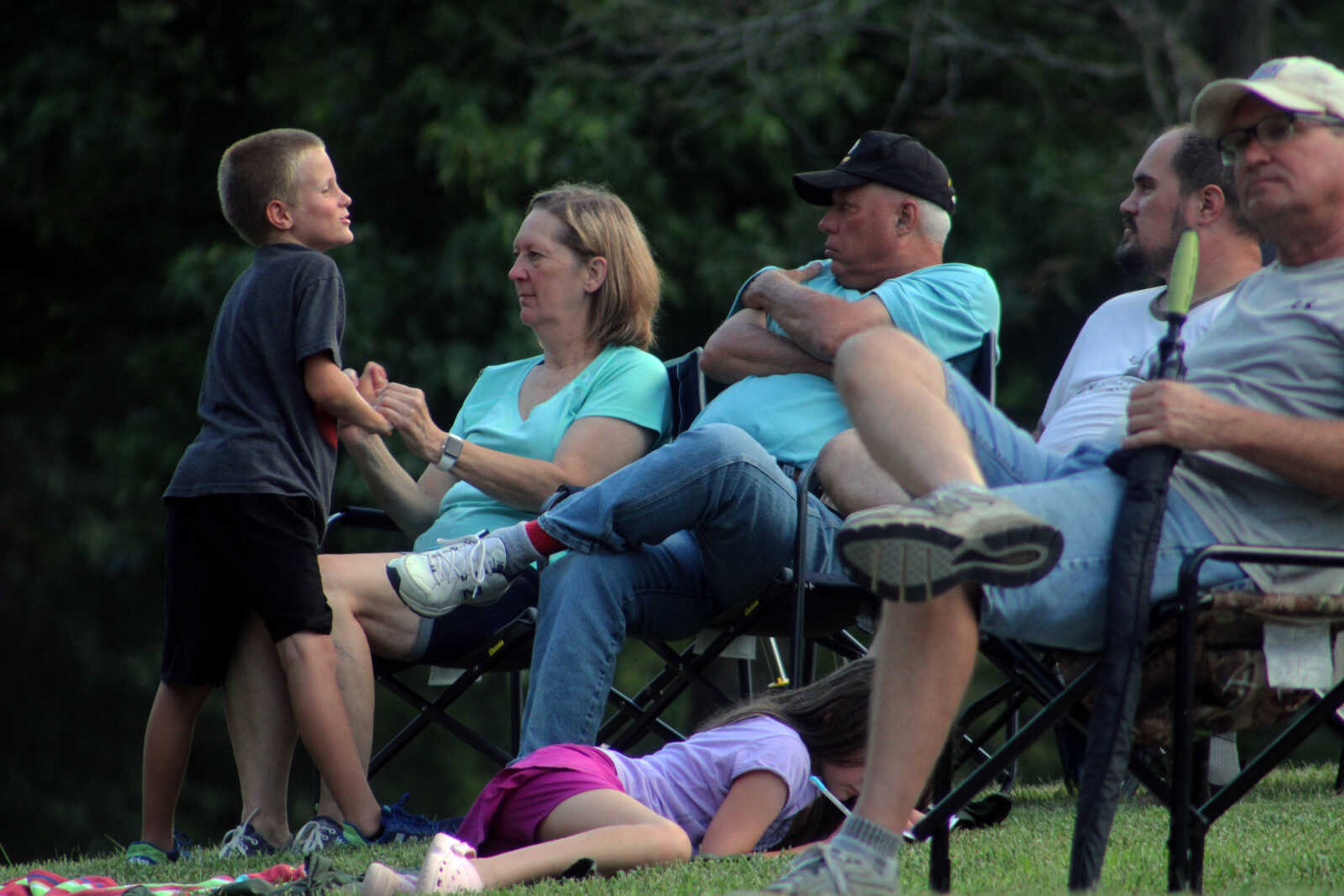 Community members sit together and enjoy music by the Jackson Municipal Band at the Nick Leist Memorial Bandshell in Jackson City Park on Thursday, July 15, 2021, in Jackson.