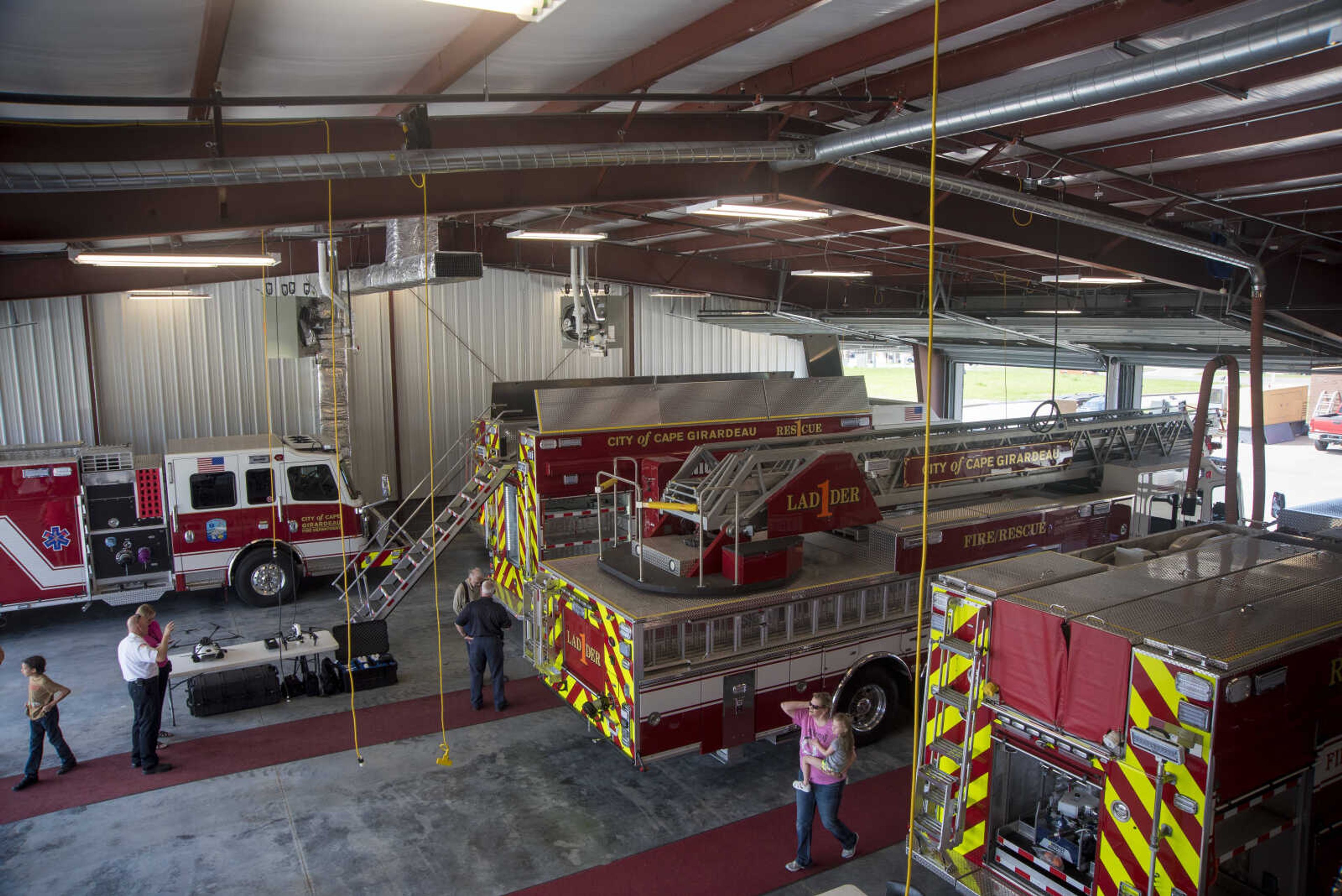 People view new fire trucks during the showing of the six Cape Girardeau fire trucks purchased at fire station number two Saturday, April 15, 2017 in Cape Girardeau. The National Fire Protection Association recommends fire departments to rotate their fleet every 10 years costing approximately $3.8 million dollars.