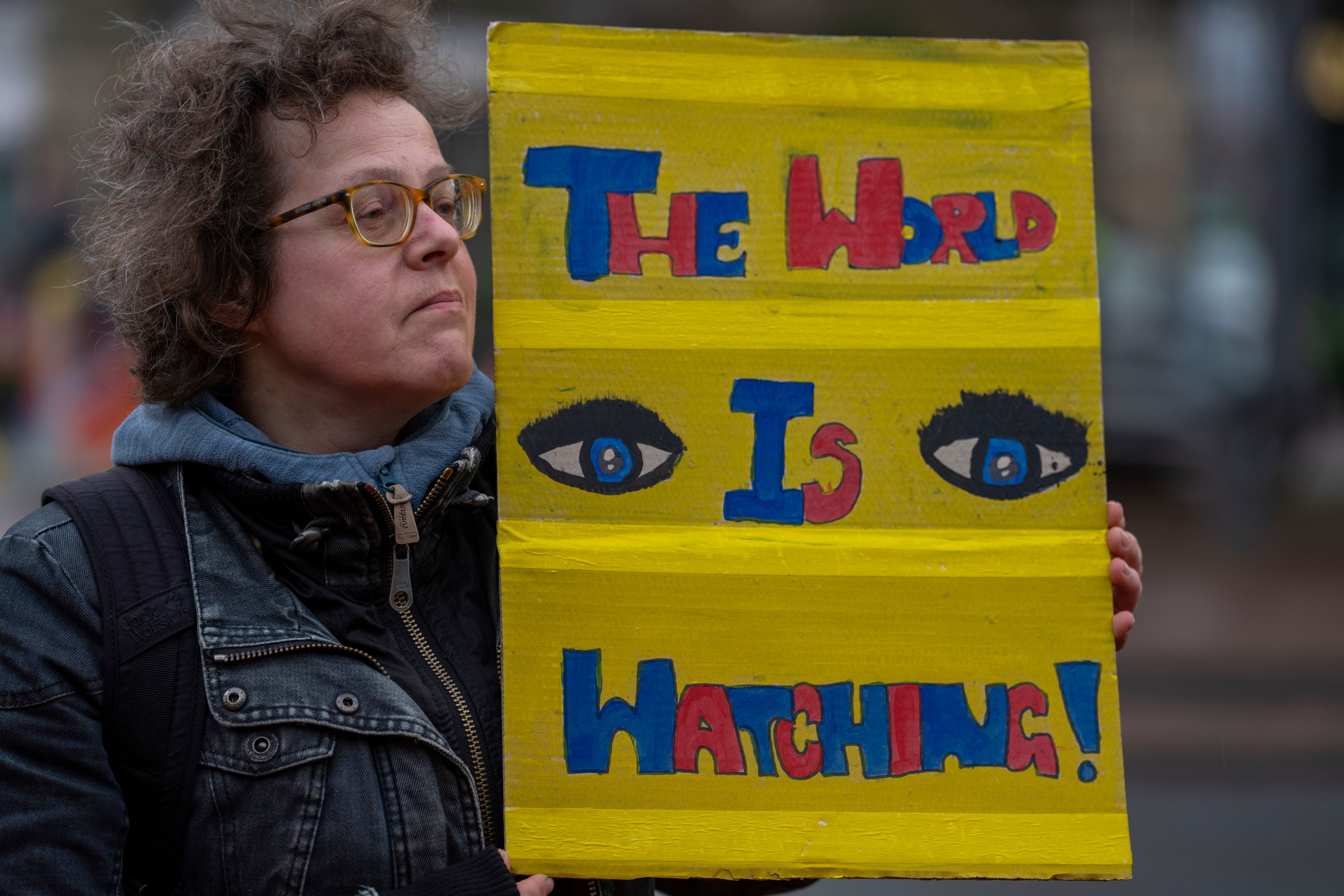 Activists protest outside the International Court of Justice, in The Hague, Netherlands, as it opens hearings into what countries worldwide are legally required to do to combat climate change and help vulnerable nations fight its devastating impact, Monday, Dec. 2, 2024. (AP Photo/Peter Dejong)