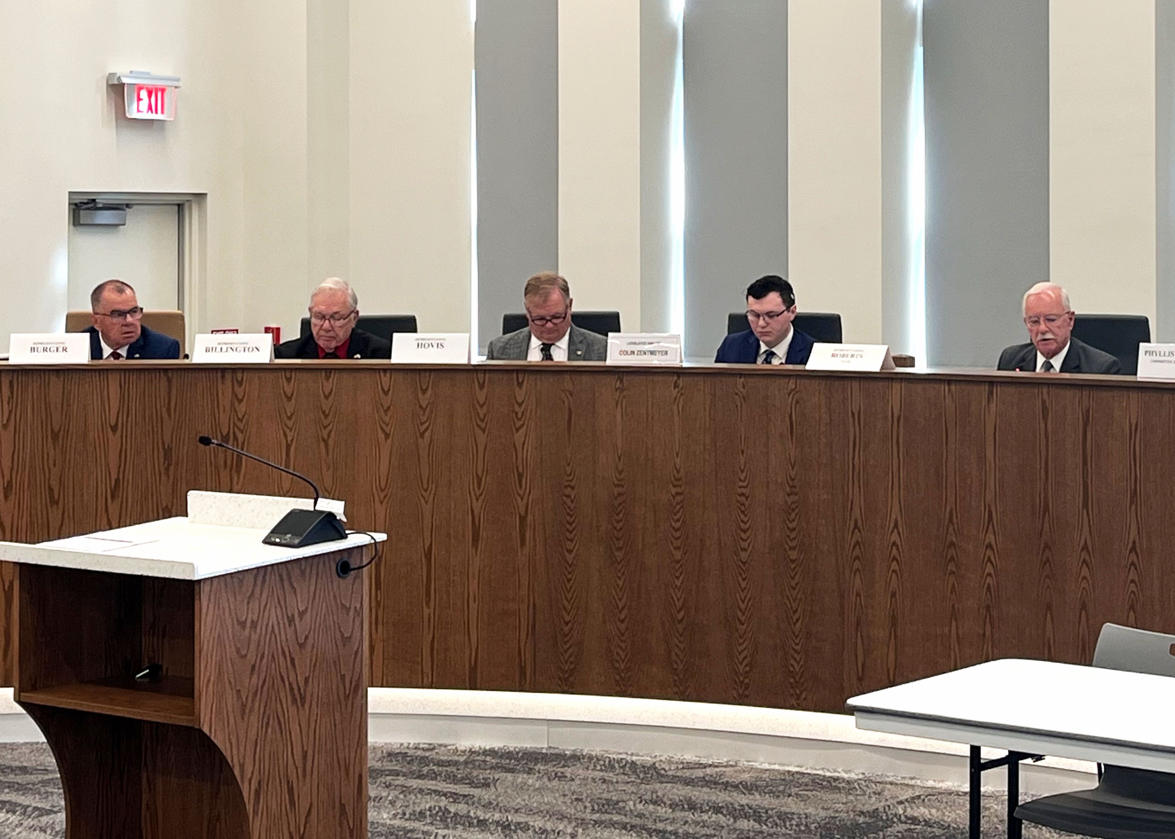 From left, Missouri state representatives Jamie Burger, Hardy Billington, Barry Hovis and legislative analyst Colin Zentmeyer listen as Special Interim Committee on Illegal Immigrant Crimes chair Lane Roberts addresses the audience during a hearing Wednesday, Sept. 25, at City Hall in Cape Girardeau. 